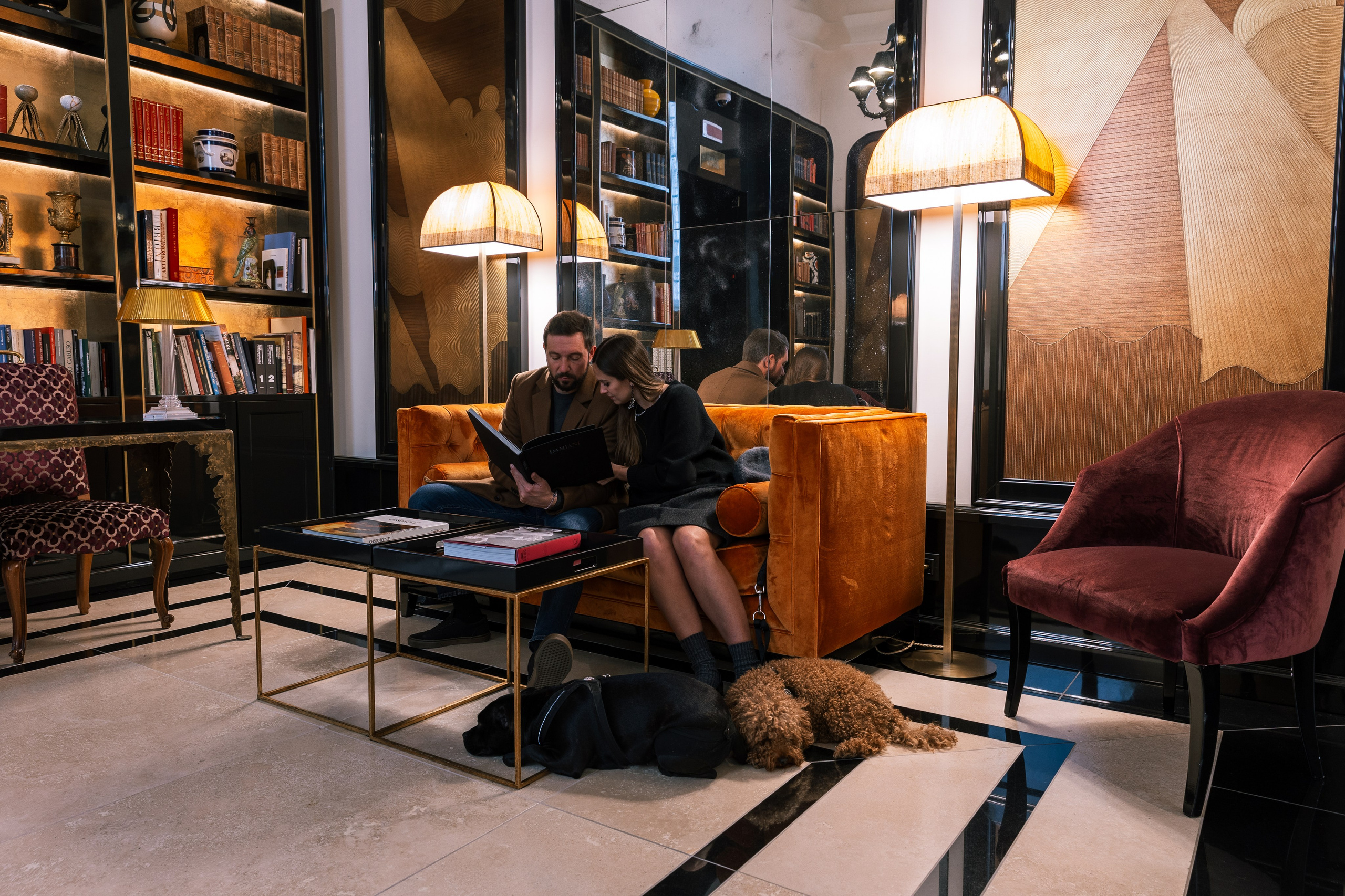 Cinematic luxury photography of a couple in an elegant, dimly lit lounge at Palazzo Ripetta, Rome, capturing an intimate and sophisticated ambiance.