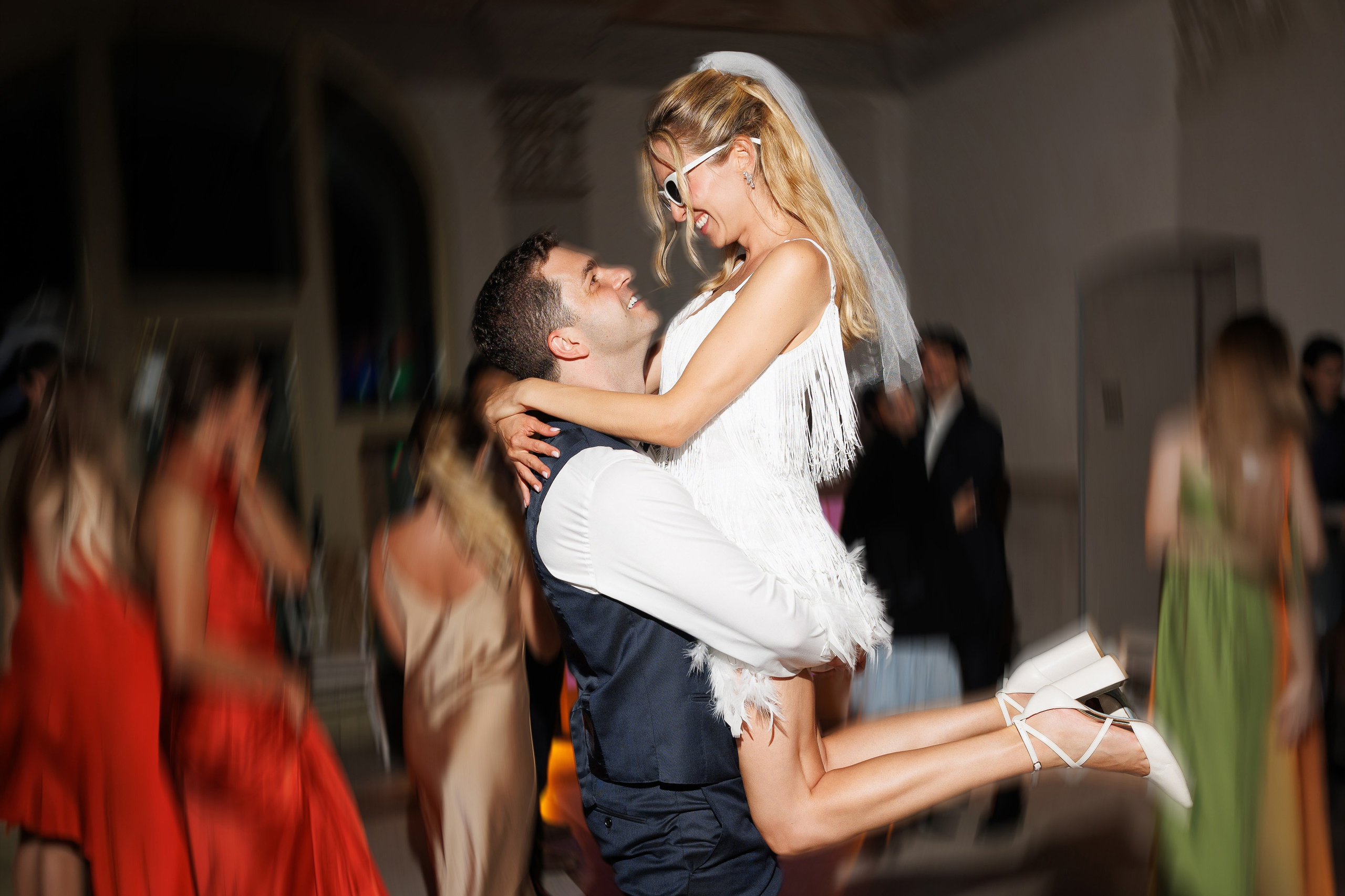 Couple sharing first kiss during wedding reception — candid wedding photography Ontario