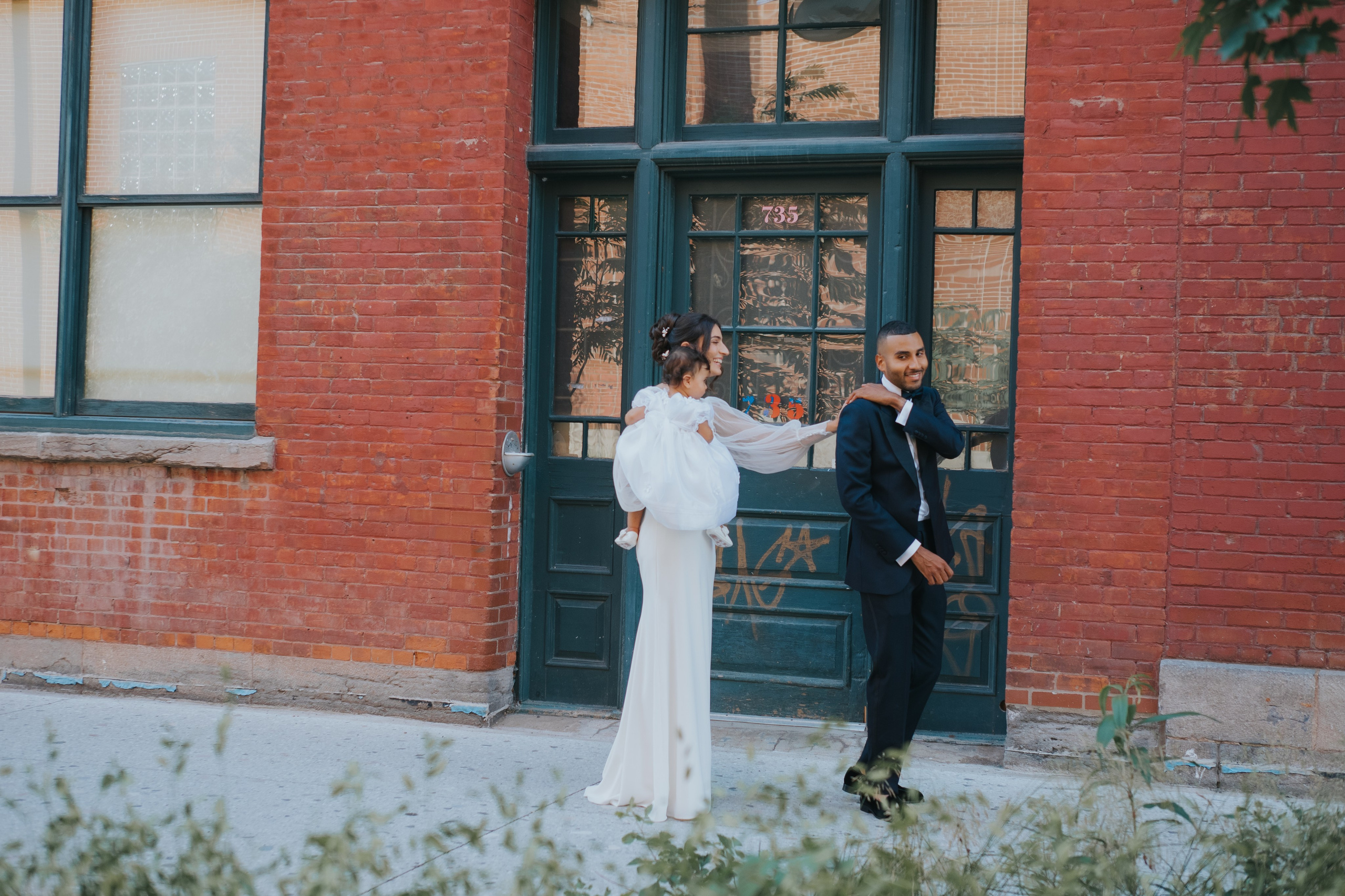 Bride tapping groom on the shoulder for their first look — candid wedding photography by Muriel Oe Photo