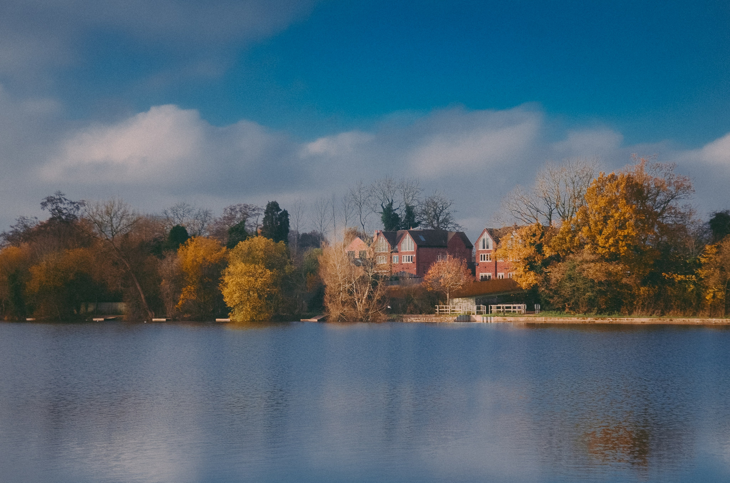 Calm lake view at Earlswood Lakes Warwickshire with autumn colours and reflections, beautiful outdoor photography location near Solihull