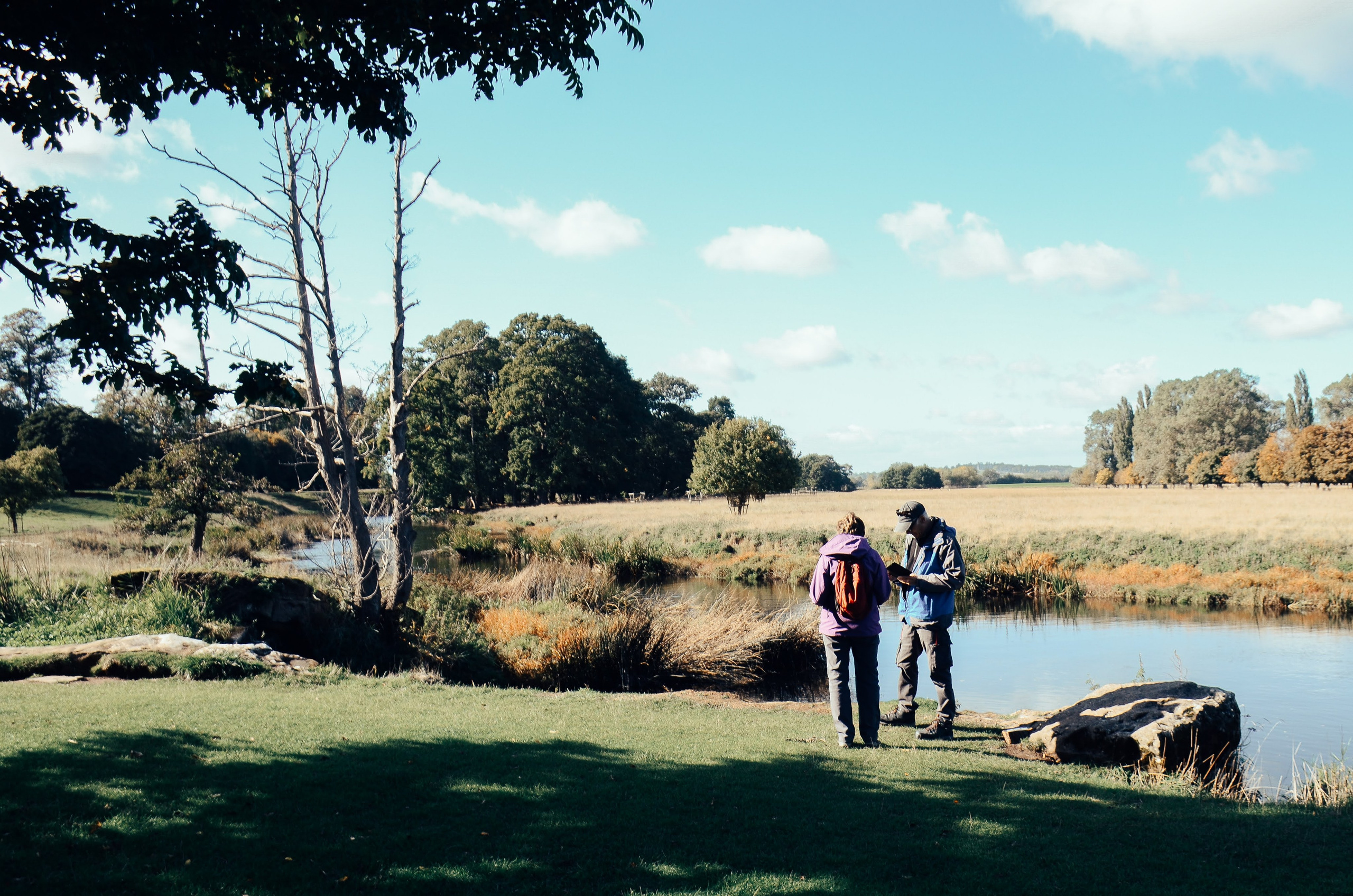 Family walking by the lake at Charlecote Park Warwickshire, beautiful outdoor family photoshoot location near Stratford upon Avon
