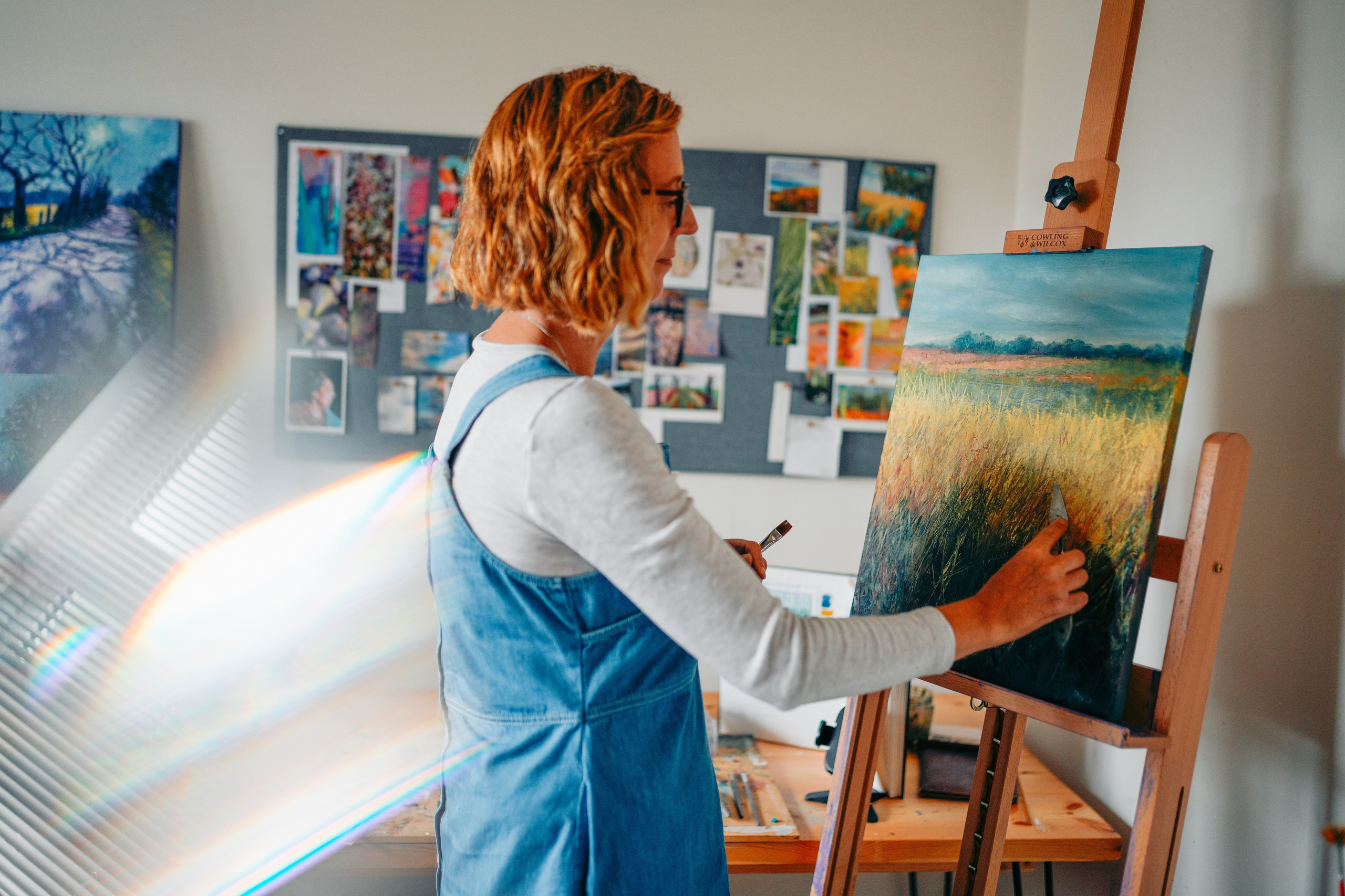 The artist is painting.  Art and brand photography. 