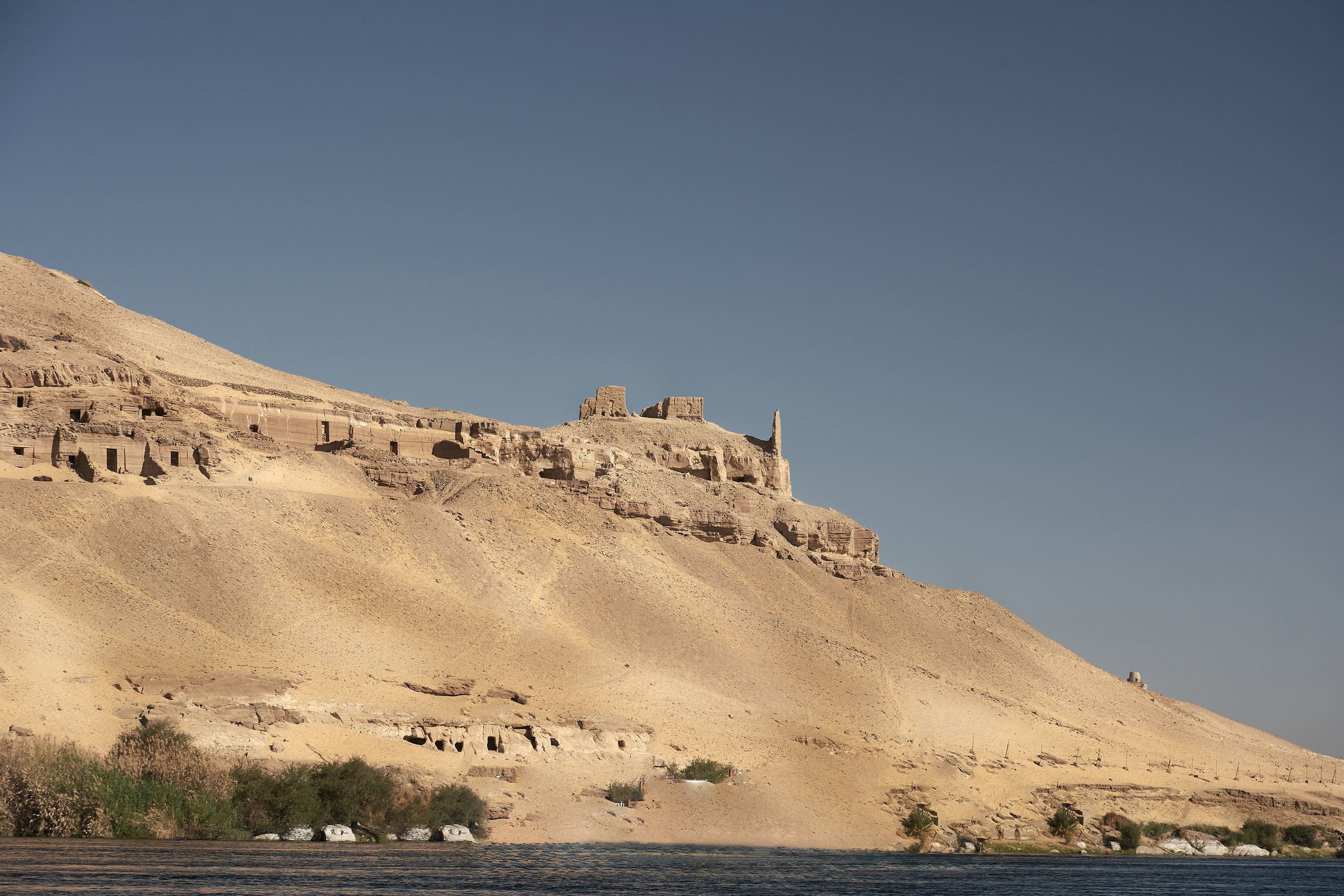 Rock-cut tombs along ancient Egyptian clifftop