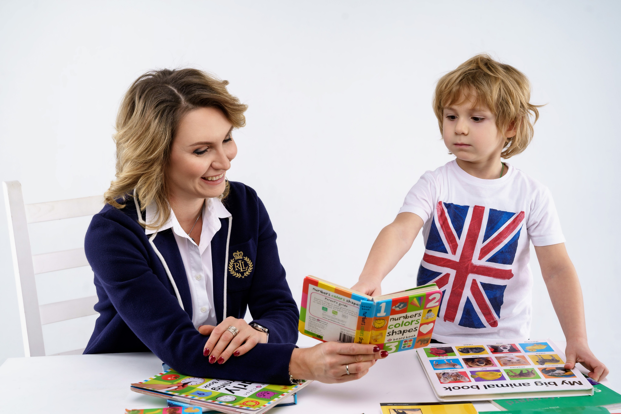 Woman in a teacher's outfit with a textbook, teaching a young boy a foreign language, commercial advertisement photo for language school