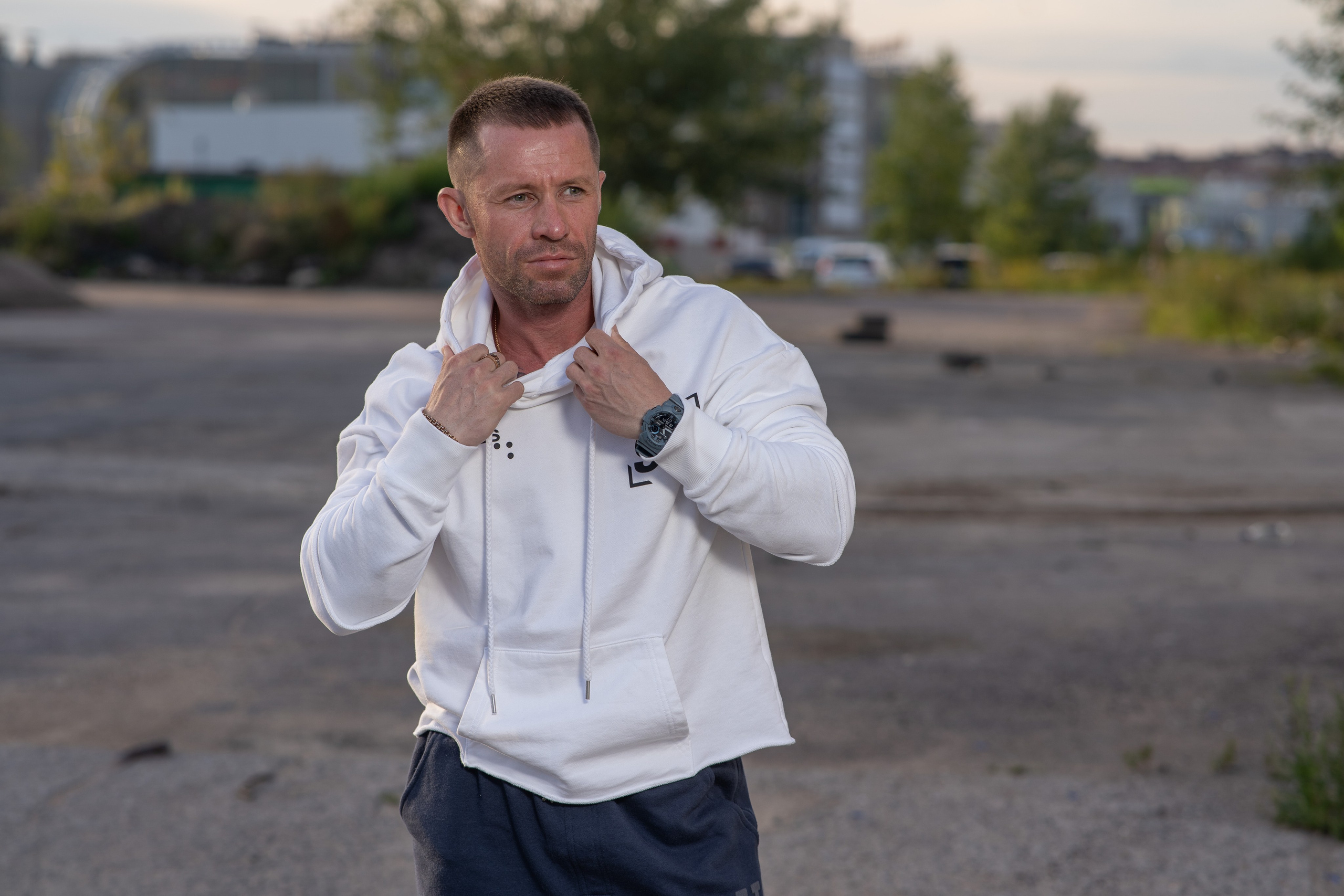 Athletic man in a white hoodie outdoors, commercial product photo for marketplace advertising by Studio K20