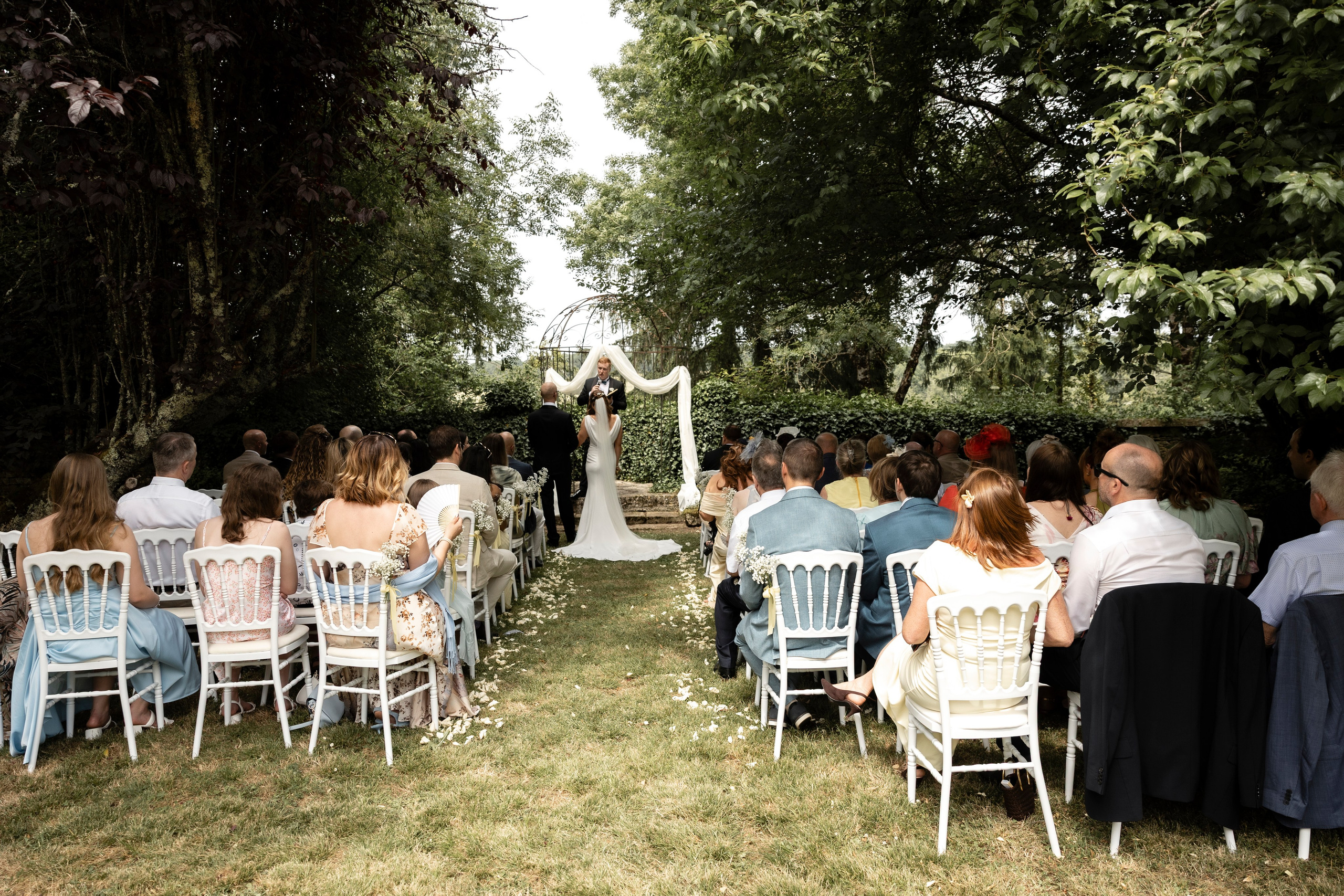 Bride and groom standing together on a historic stone balcony at Château Sentout during their wedding day in France.