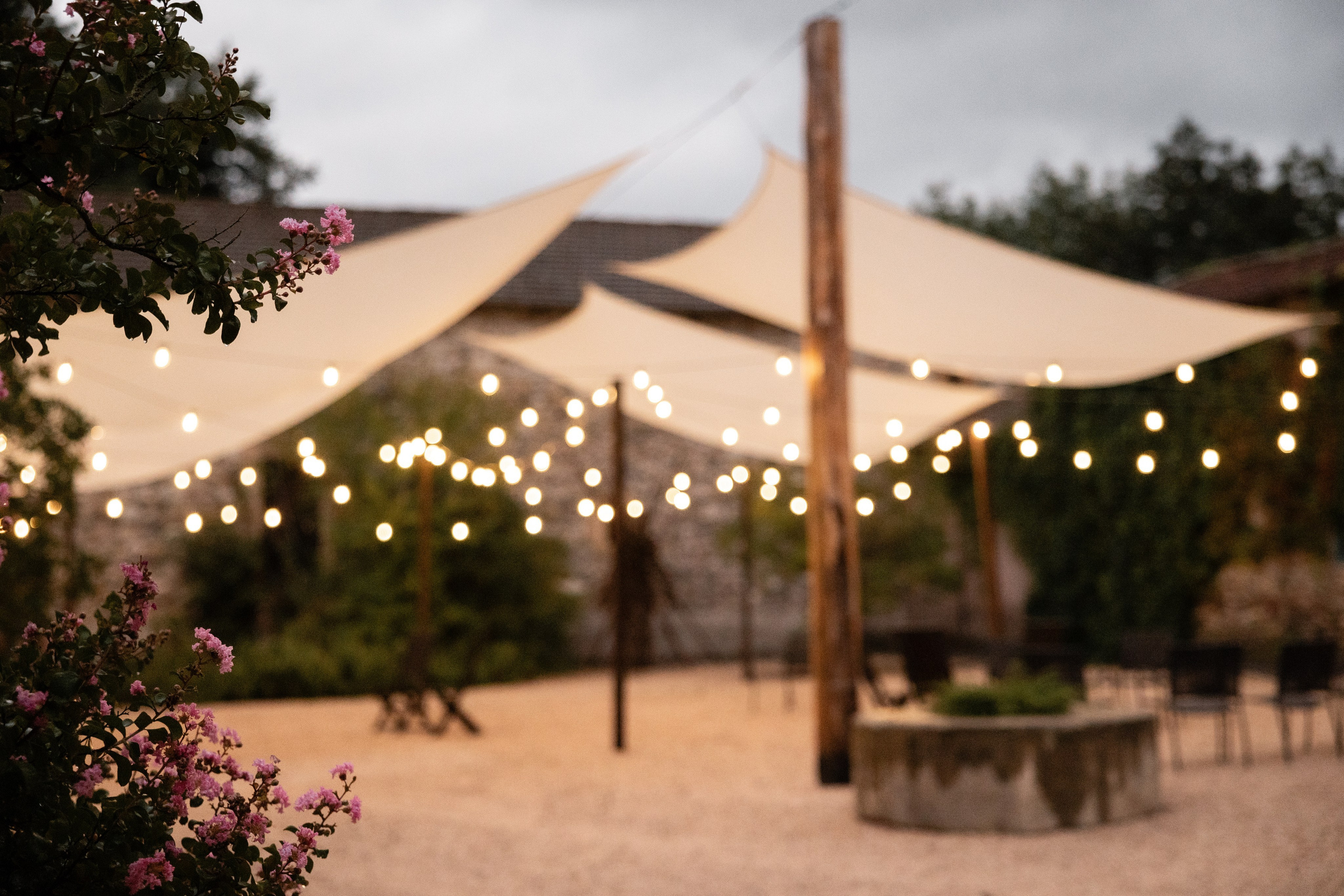 Marquee with festoon lights at a Château de Saint-Martory wedding, evening