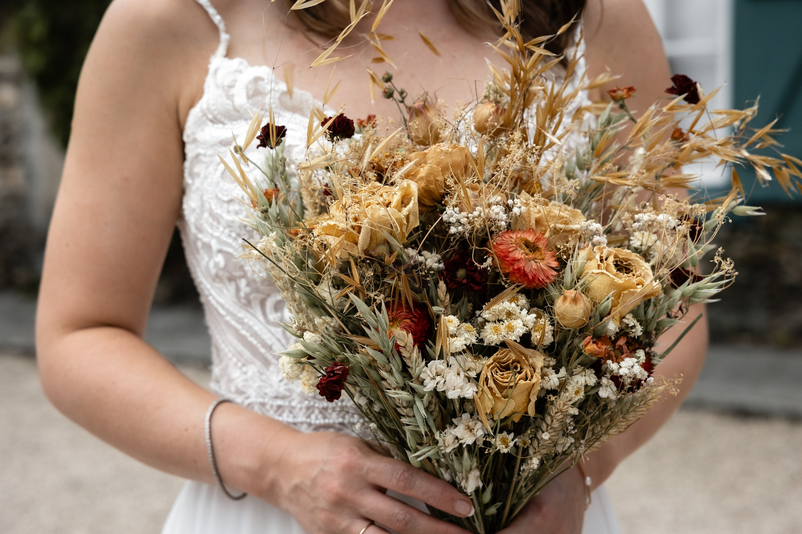 Bride holding a dried flower bouquet at Château de Saint-Martory, Southwest France