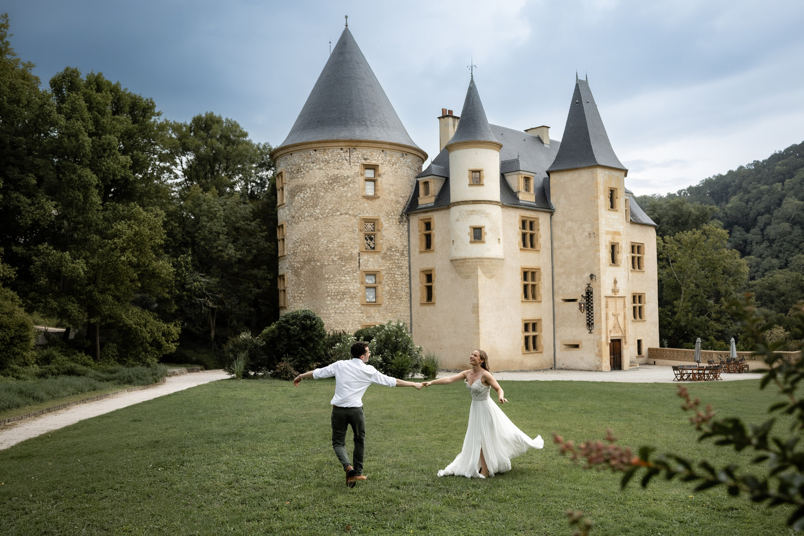 Bride and groom walking in the grounds of Château de Saint-Martory