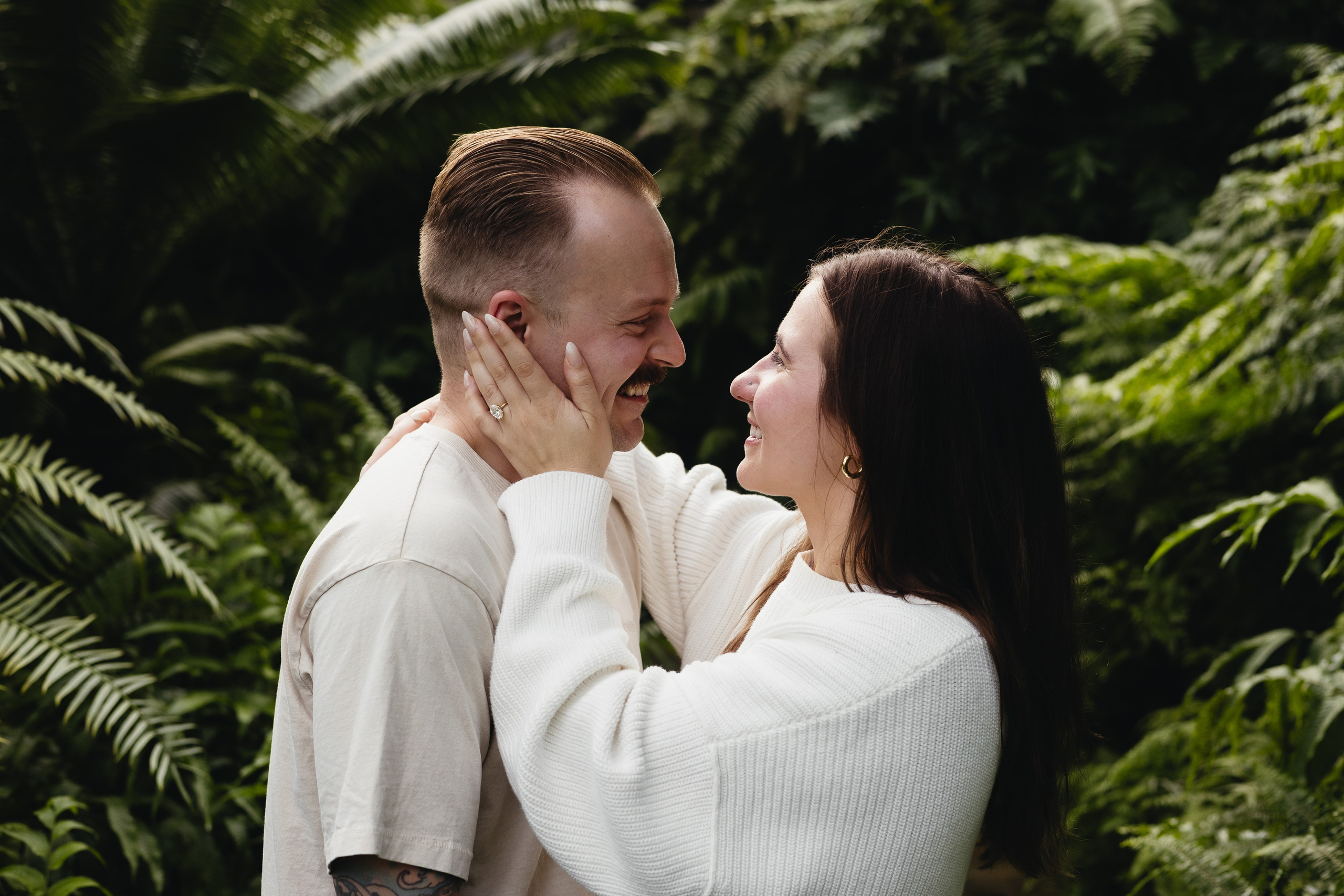 Couple smiling and looking at each other during proposal at Garfield Park Conservatory in Chicago