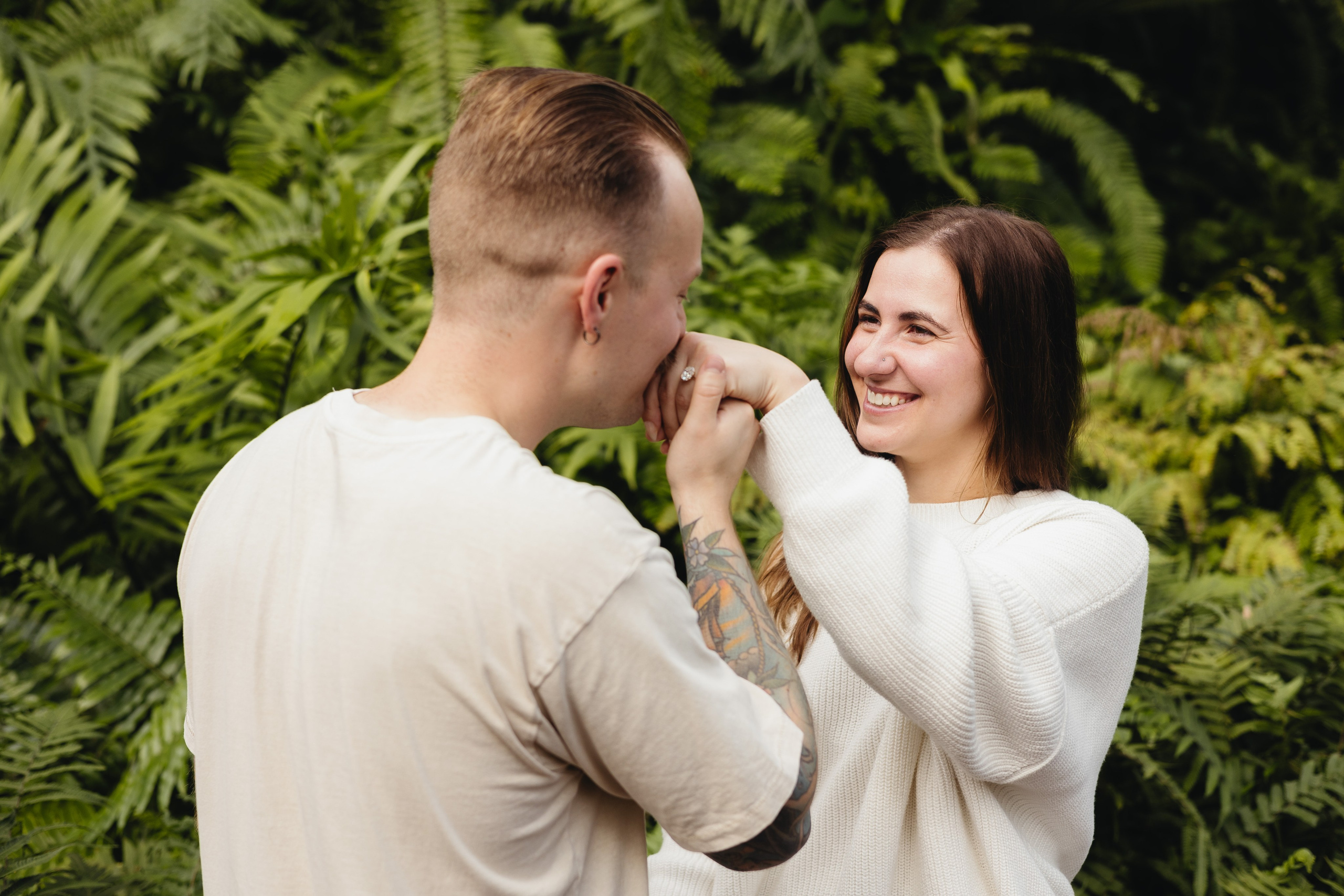 Partner kissing her hand to show engagement ring at Garfield Park Conservatory proposal in Chicago