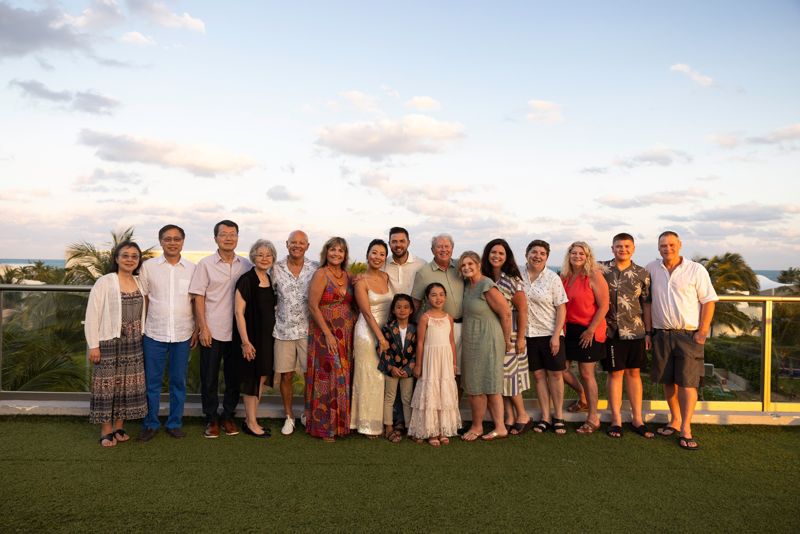 Family photo during pre-wedding dinner at a tropical destination wedding in Cancun.
