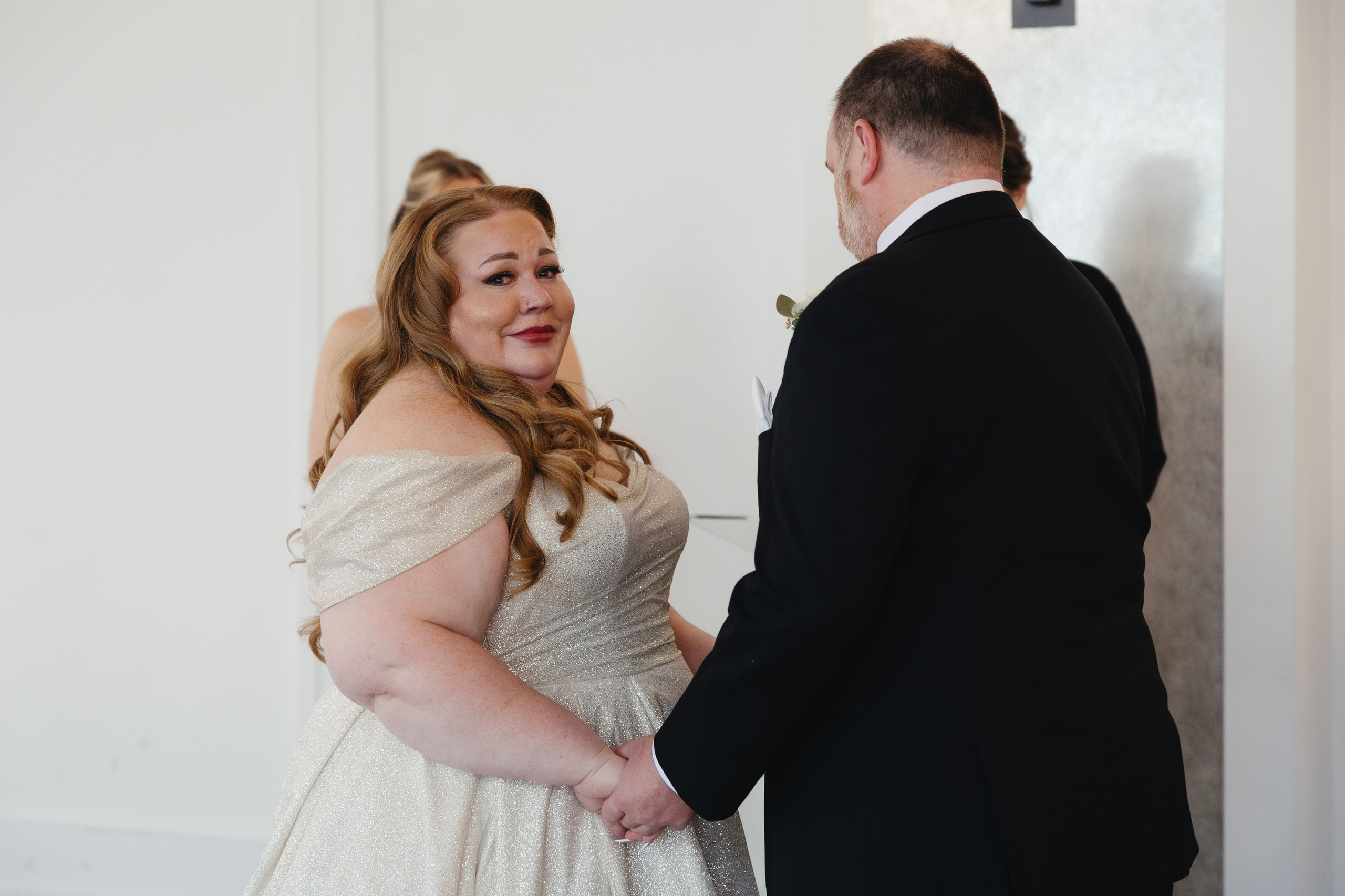 Bride and groom holding hands during the ceremony as the bride becomes emotional at The Penthouse Hyde Park