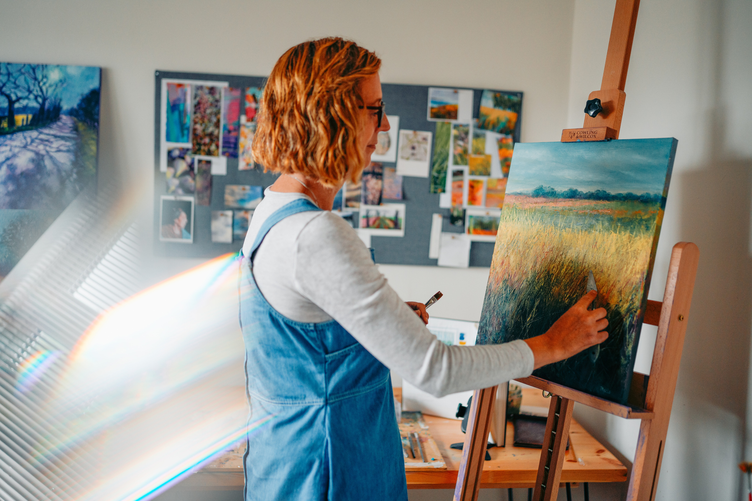 Lady is standing and painting magic. Art and brand photography.