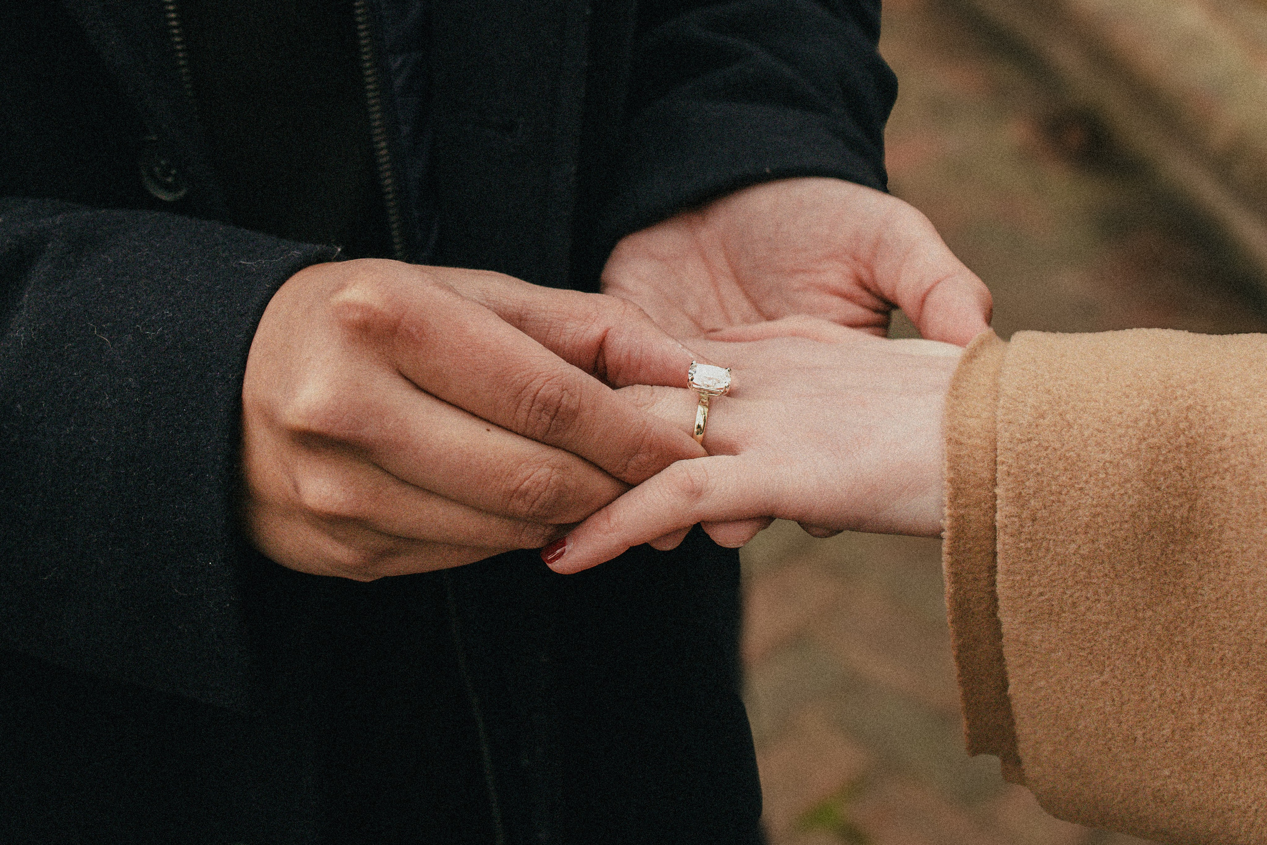 Happy fiancé showing her sparkling engagement ring right after the romantic proposal