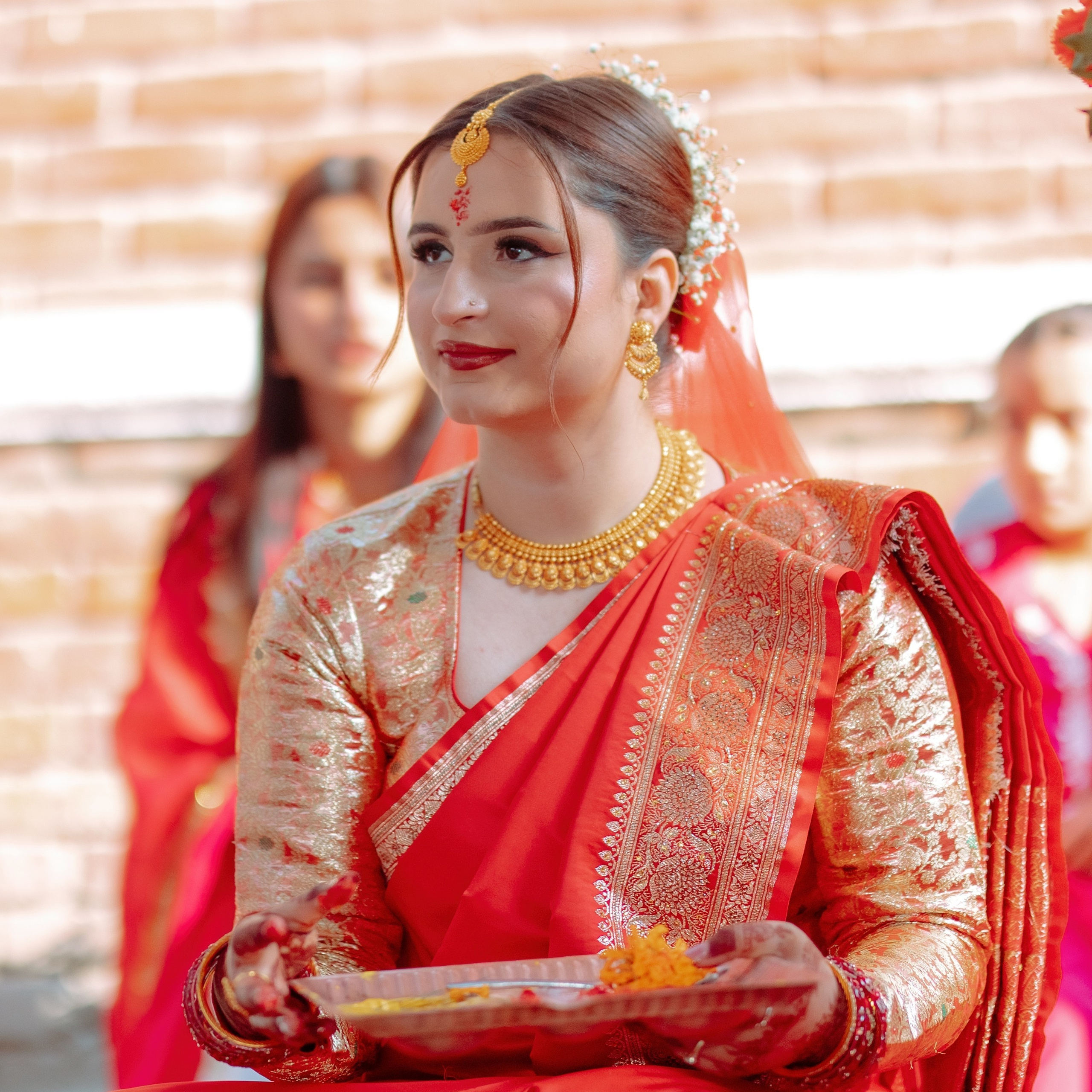 Close-up shot of a Nepali bride performing wedding rituals, dressed in a vibrant red silk saree, in Kathmandu Nepal. captured by Poudel Digital Photography.