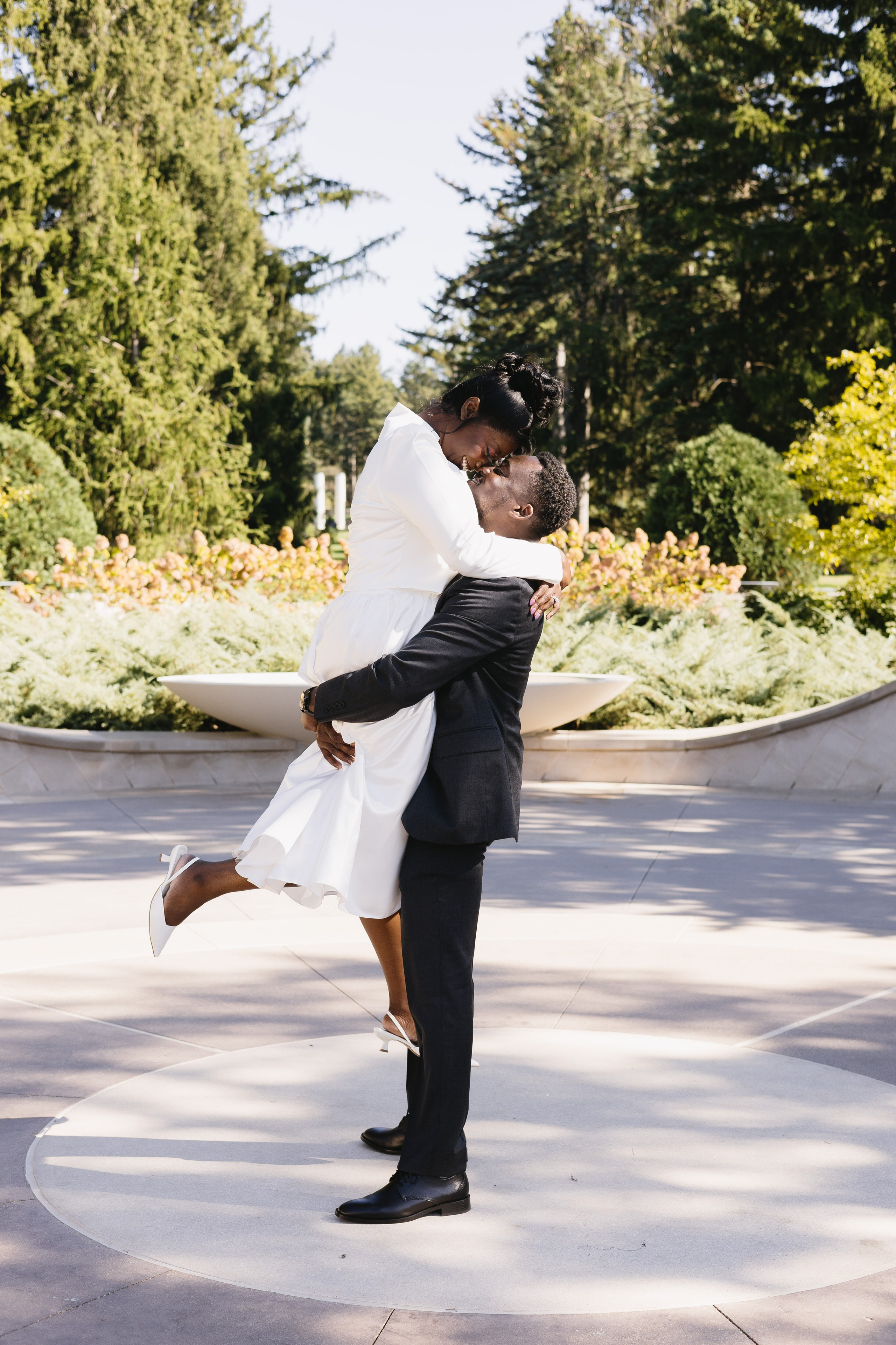 Couple embracing in a Chicago park, groom holding the bride in his arms during their intimate elopement