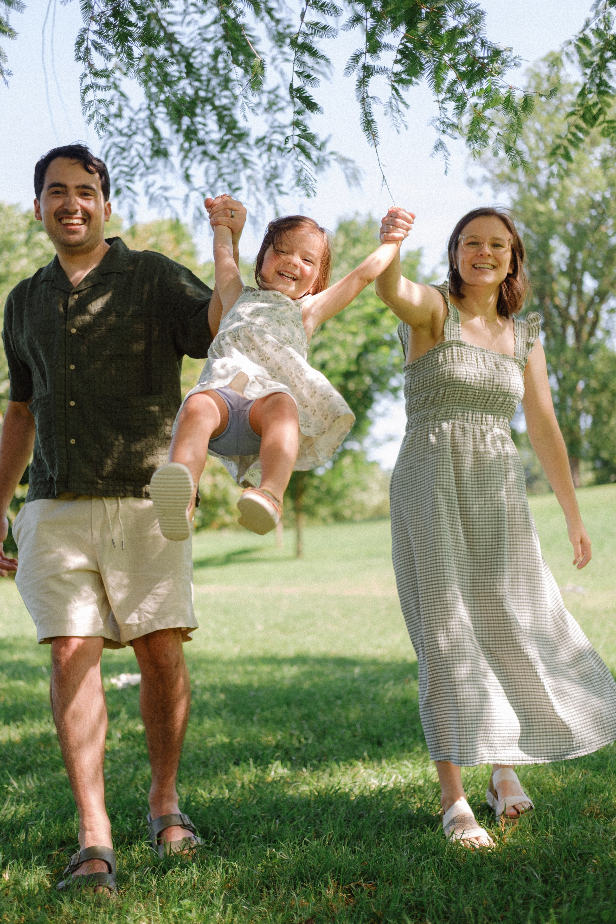 Parents are having fund and throwing their daughter in the air at Maymont Park in Richmond, VA