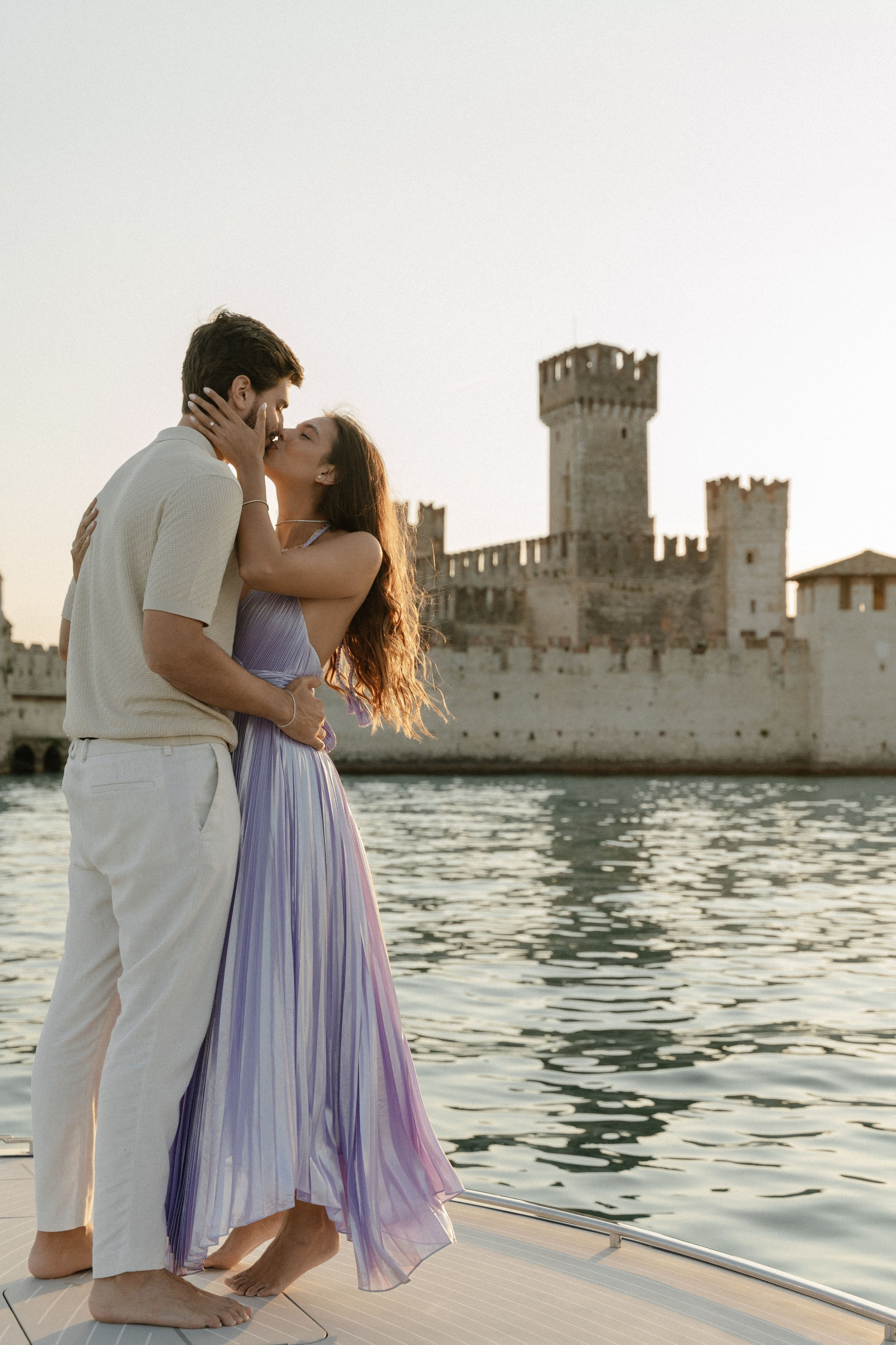 Luxury marriage proposal on a private boat at Lake Garda, romantic couple enjoying sunset in Italy