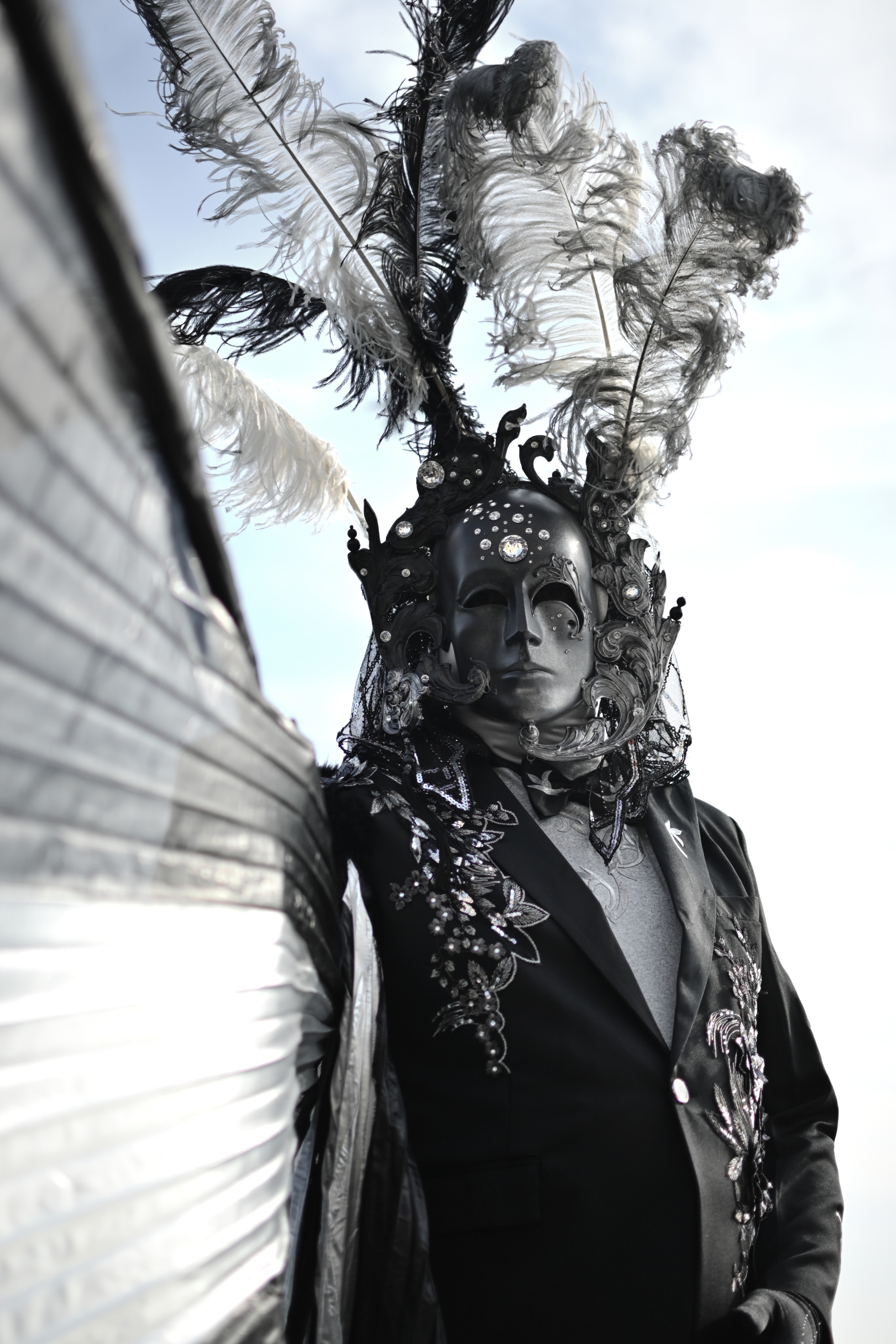 A group of costumed participants walking through the streets of Venice during Carnival. Traditional Venetian masks displayed at the carnival in Venice