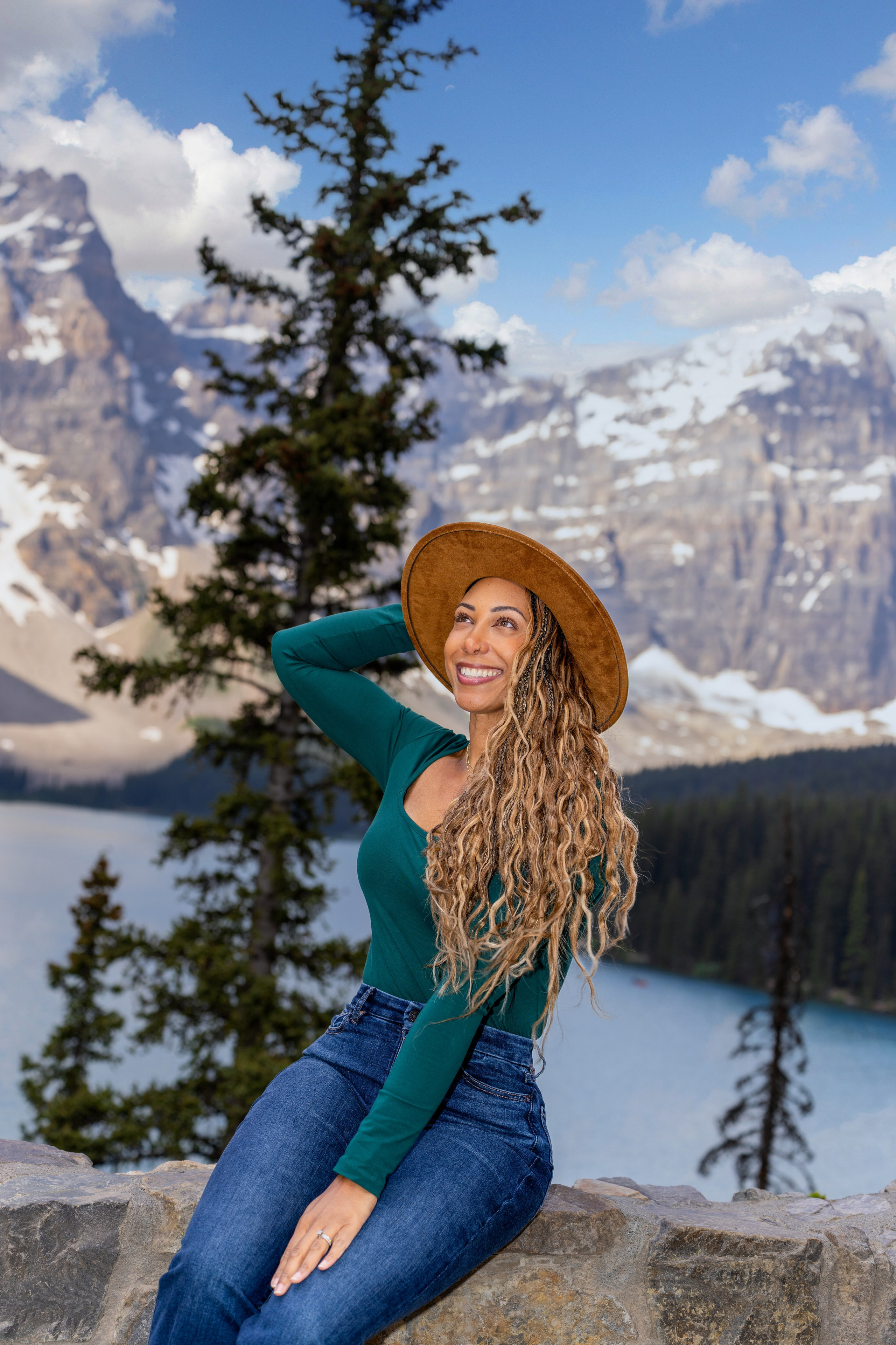 Woman posing by a pine tree at Moraine Lake, Banff National Park photo session