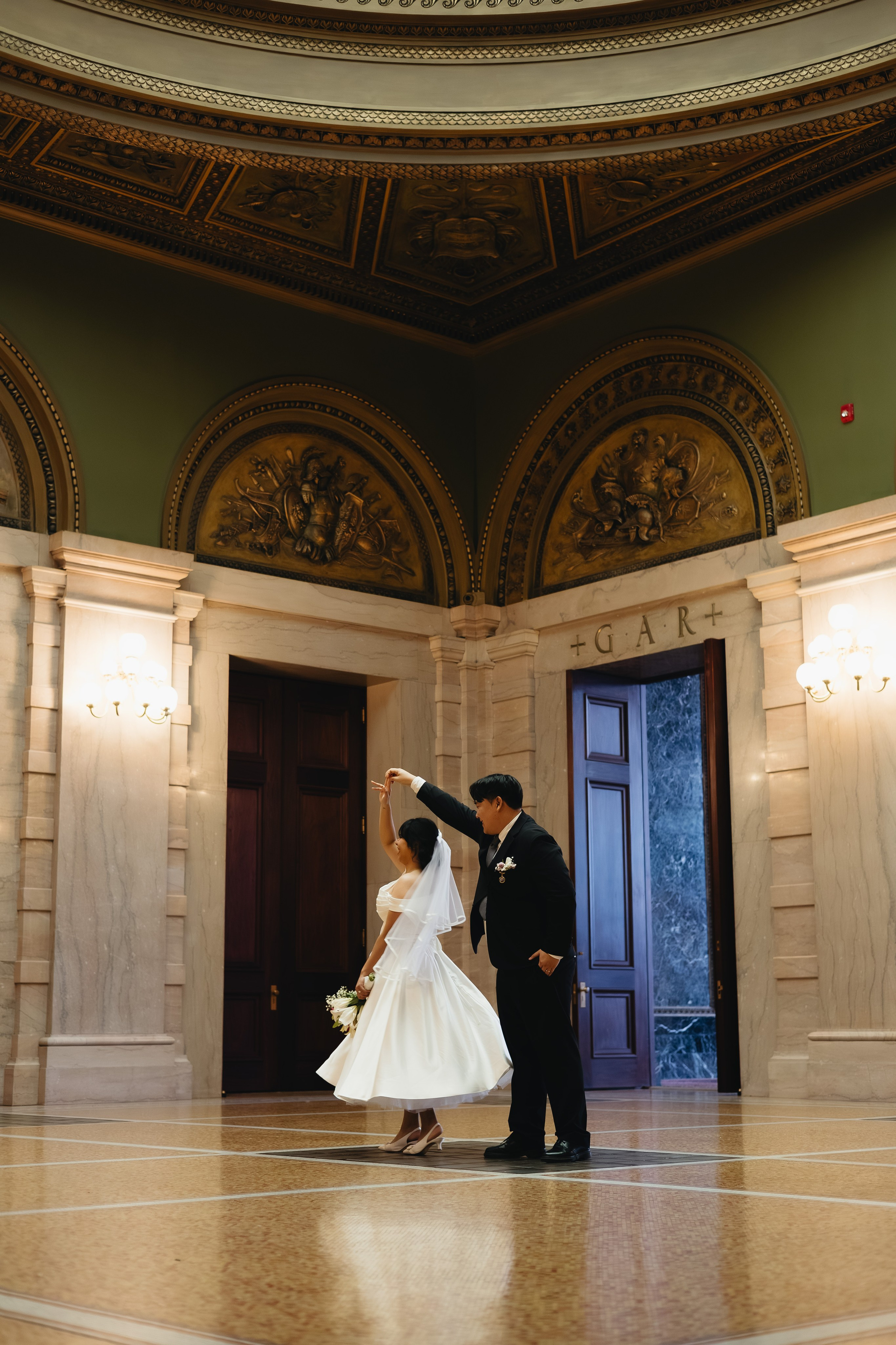 Couple dancing inside the Chicago Cultural Center during a winter elopement