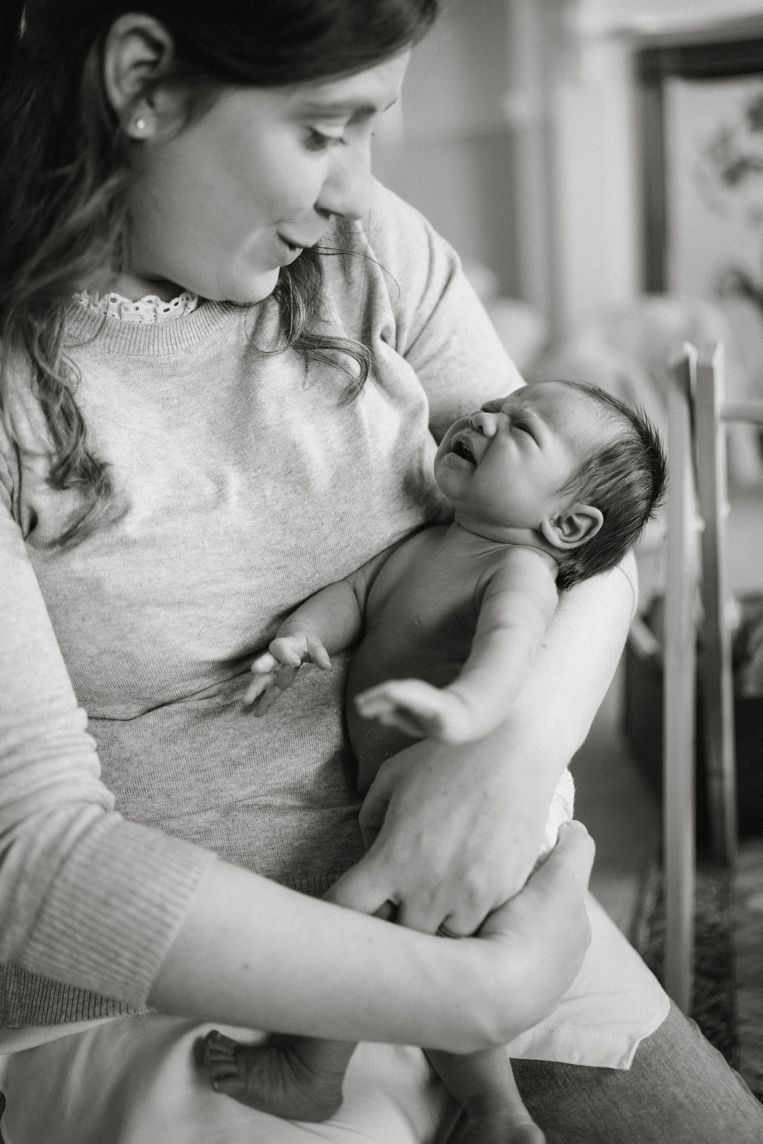 Tender black and white portrait of a mother holding her newborn baby, natural newborn photography in Knowle, Solihull