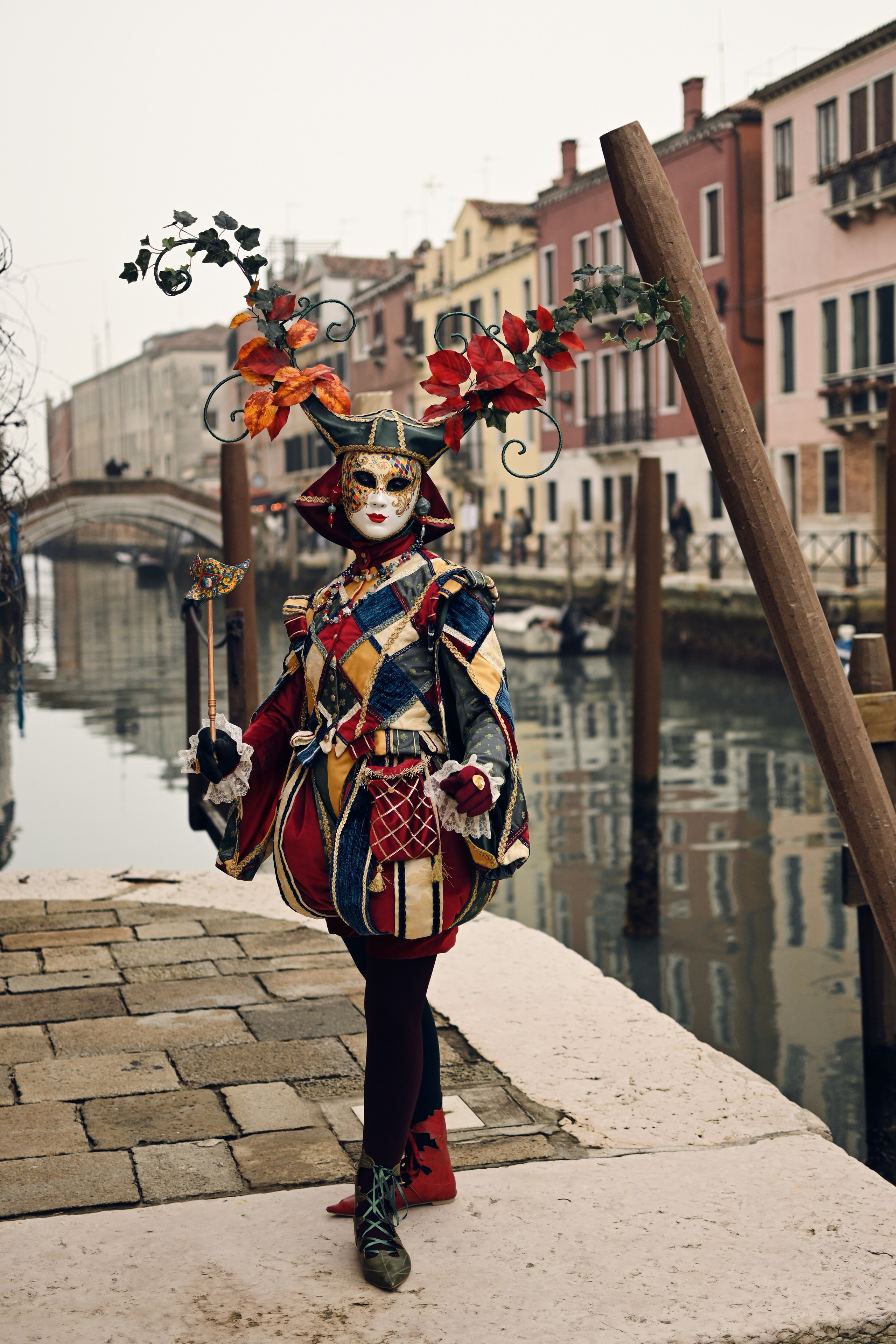 A carnival float adorned with colorful flowers and feathers passing through a Venetian square. I also enjoy exploring the quieter side streets of Venice during the carnival, where I can capture intimate and romantic portraits of couples dressed in costume. These photoshoots are always a unique and unforgettable experience for both the couples and myself.