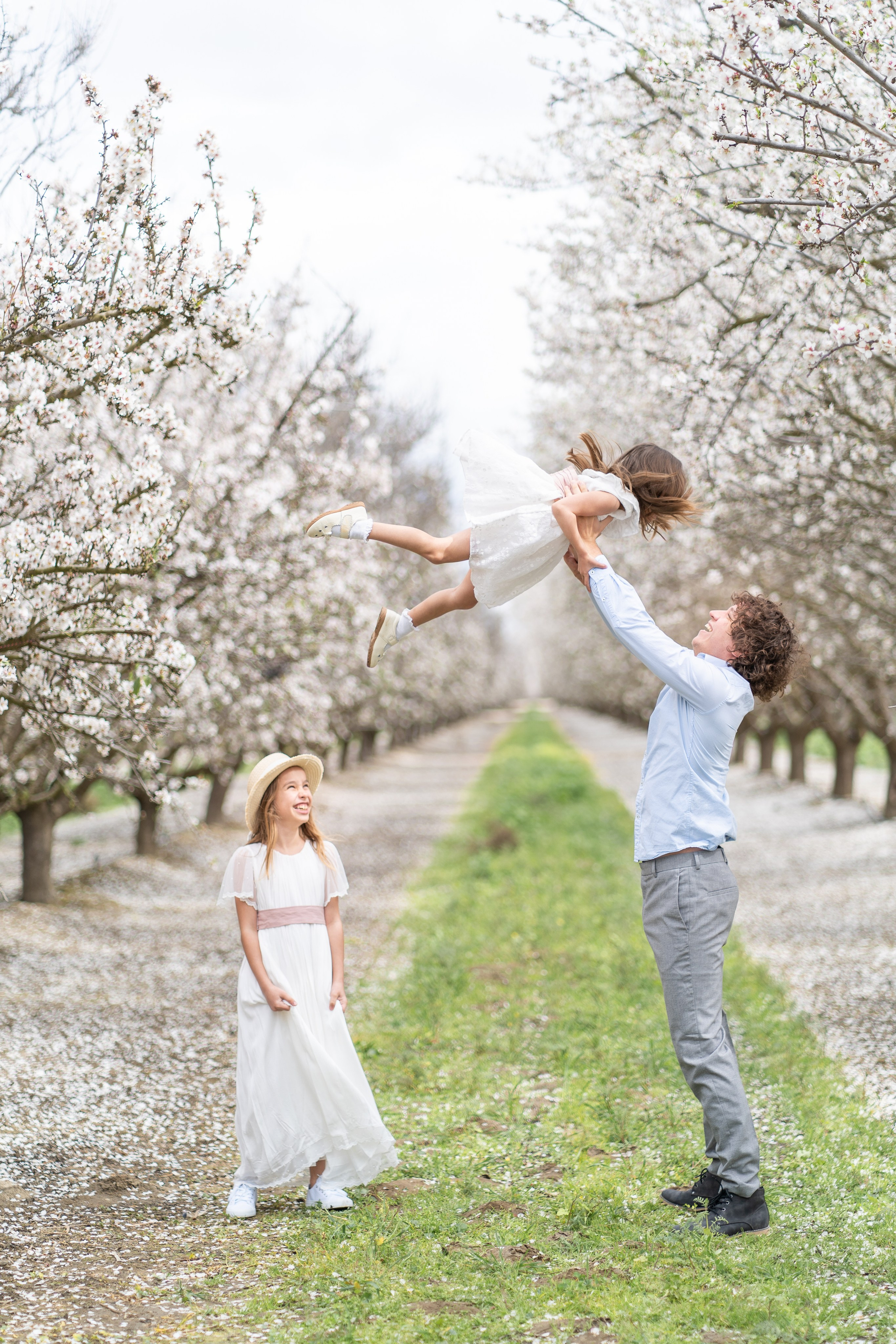 Spring family photos, maternity photography, couples session, and individual portraits surrounded by blooming almond trees.