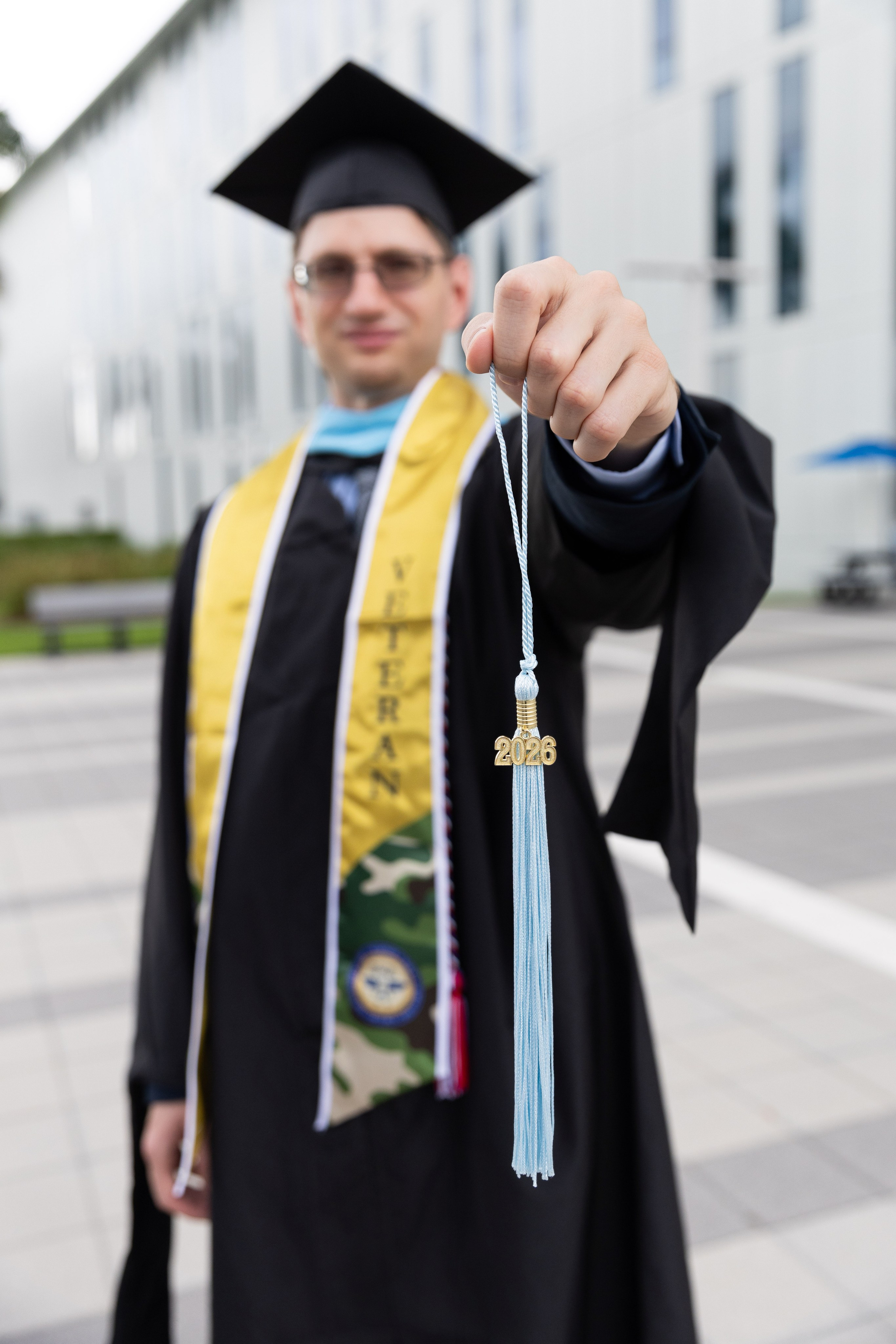 Darren displays his 2026 tassel during an FIU graduation photo session.