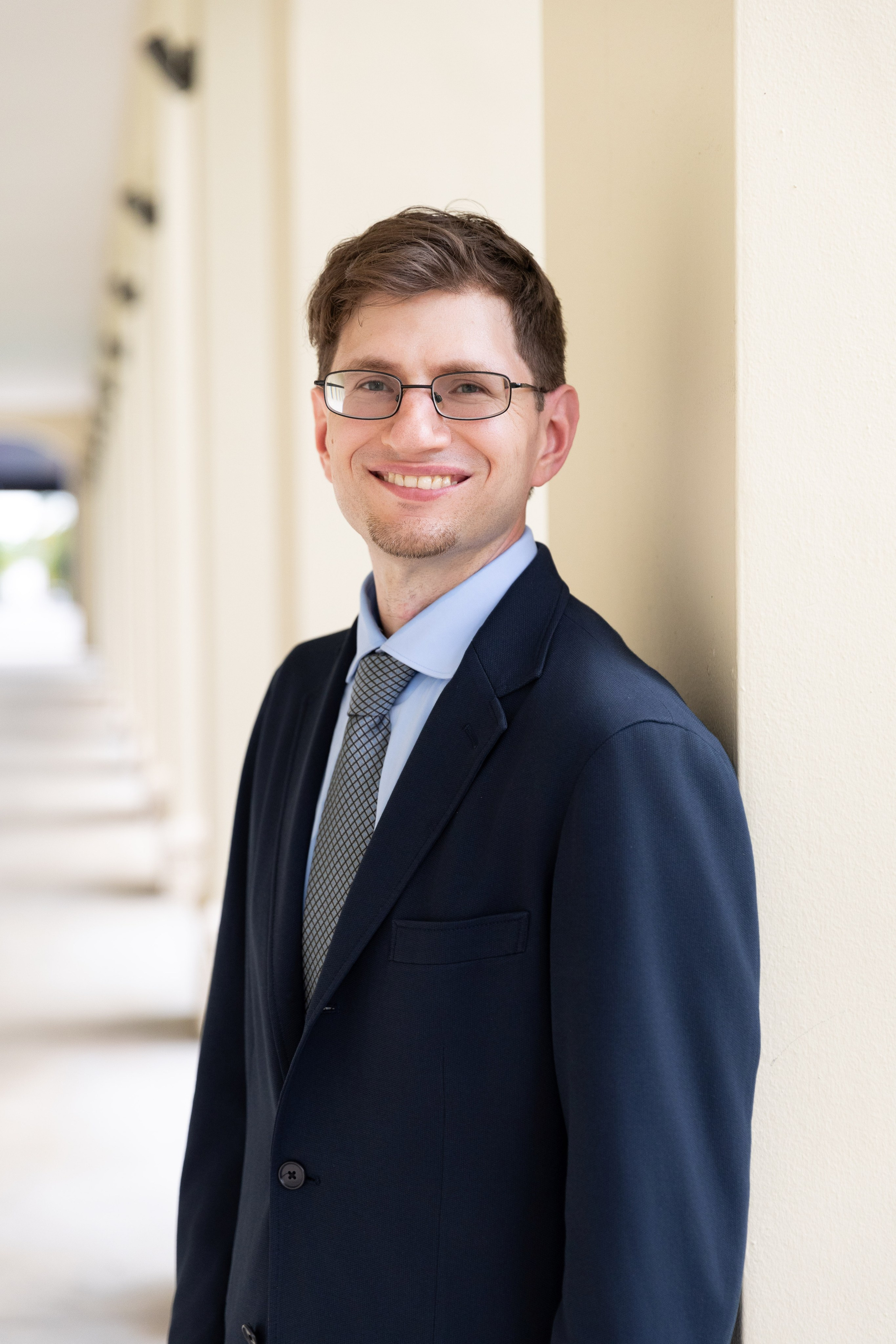 Professional portrait of Darren wearing a suit on the FIU campus.