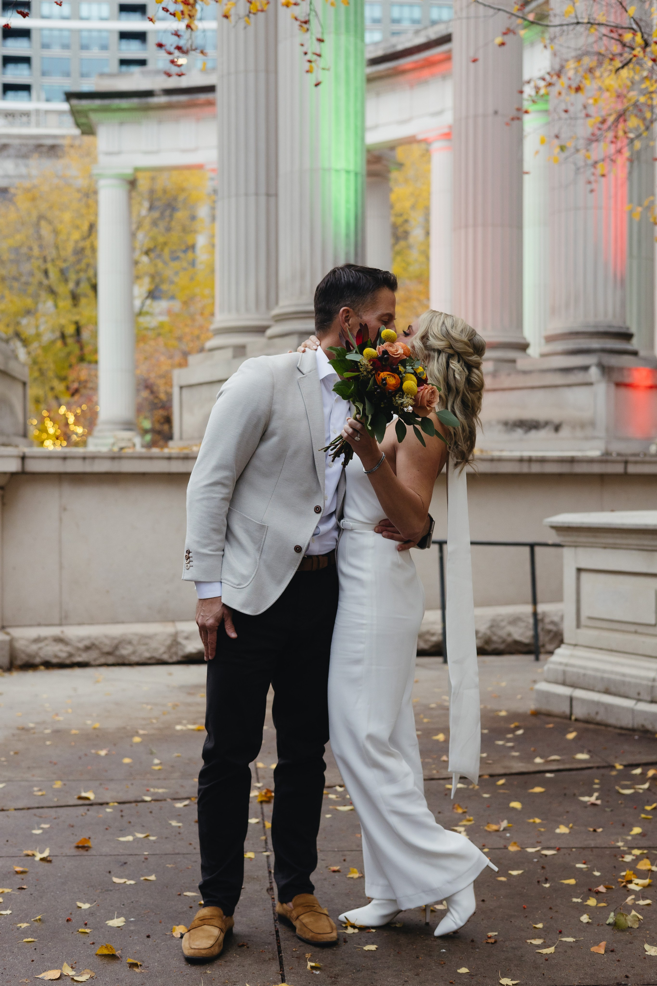 Couple kissing during their fall elopement in Millennium Park, Chicago, surrounded by autumn colors