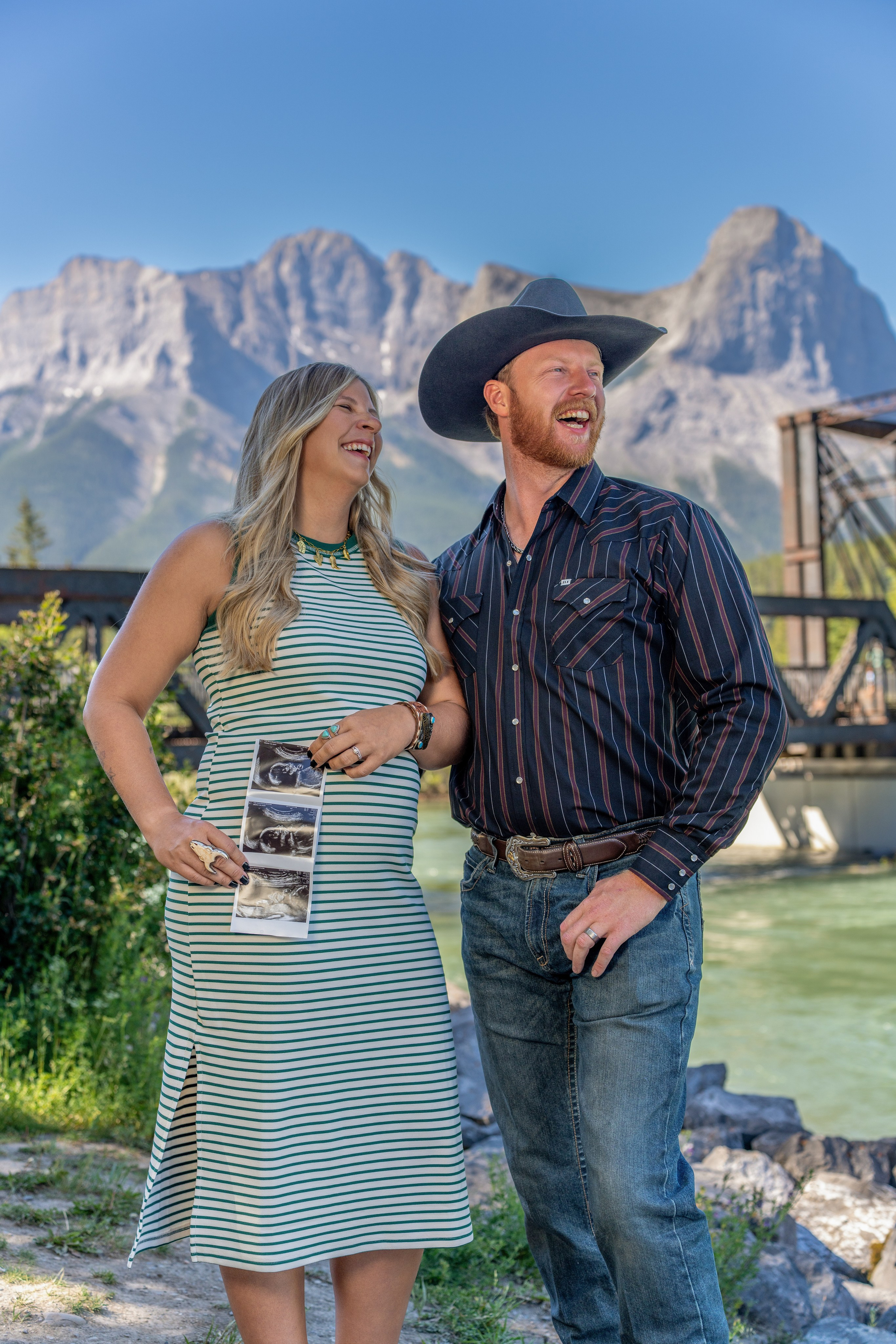 Couple posing by a mountain lake during a Canmore Maternity photo session