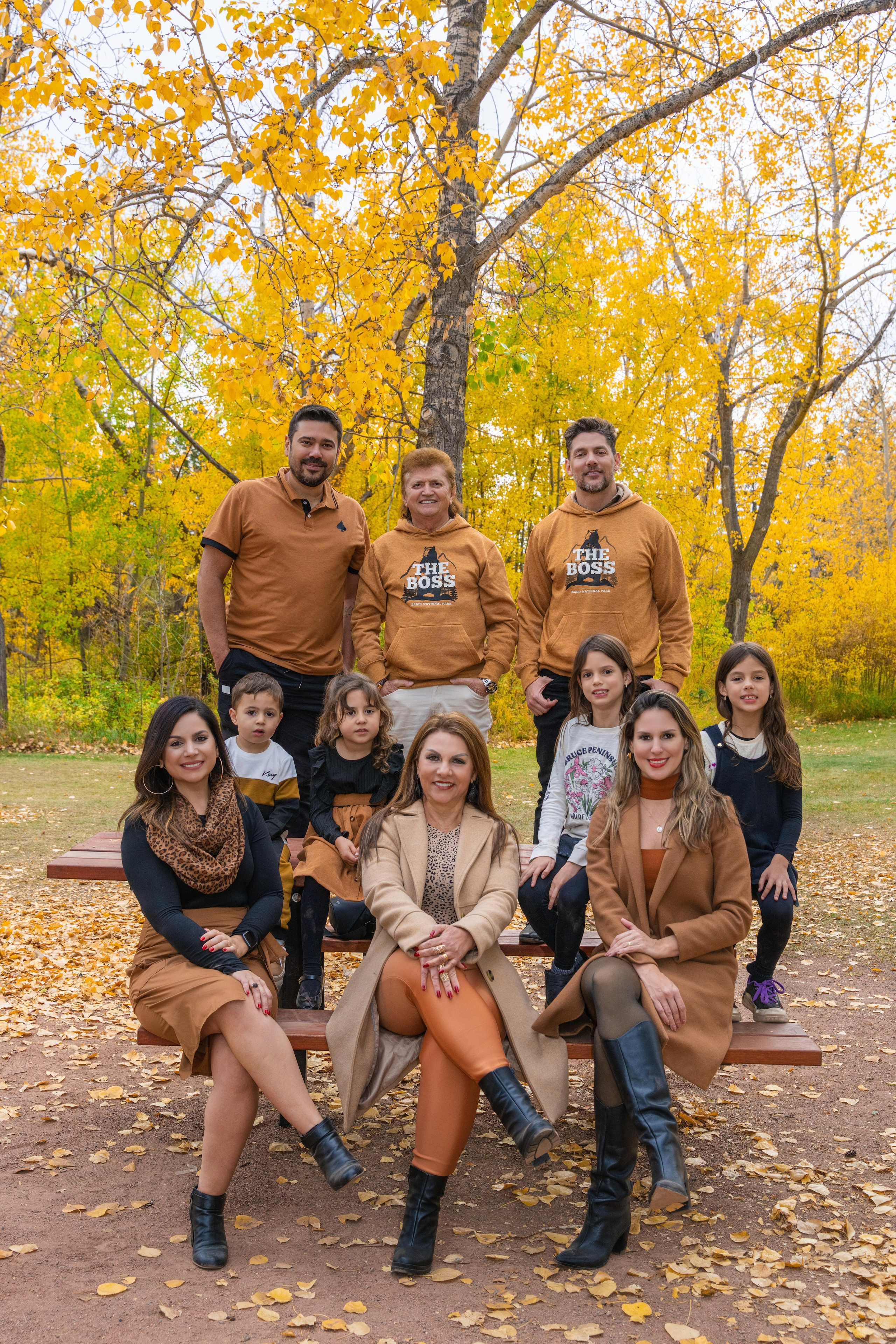 Fall family mini session in Calgary with kids and parents among yellow autumn trees