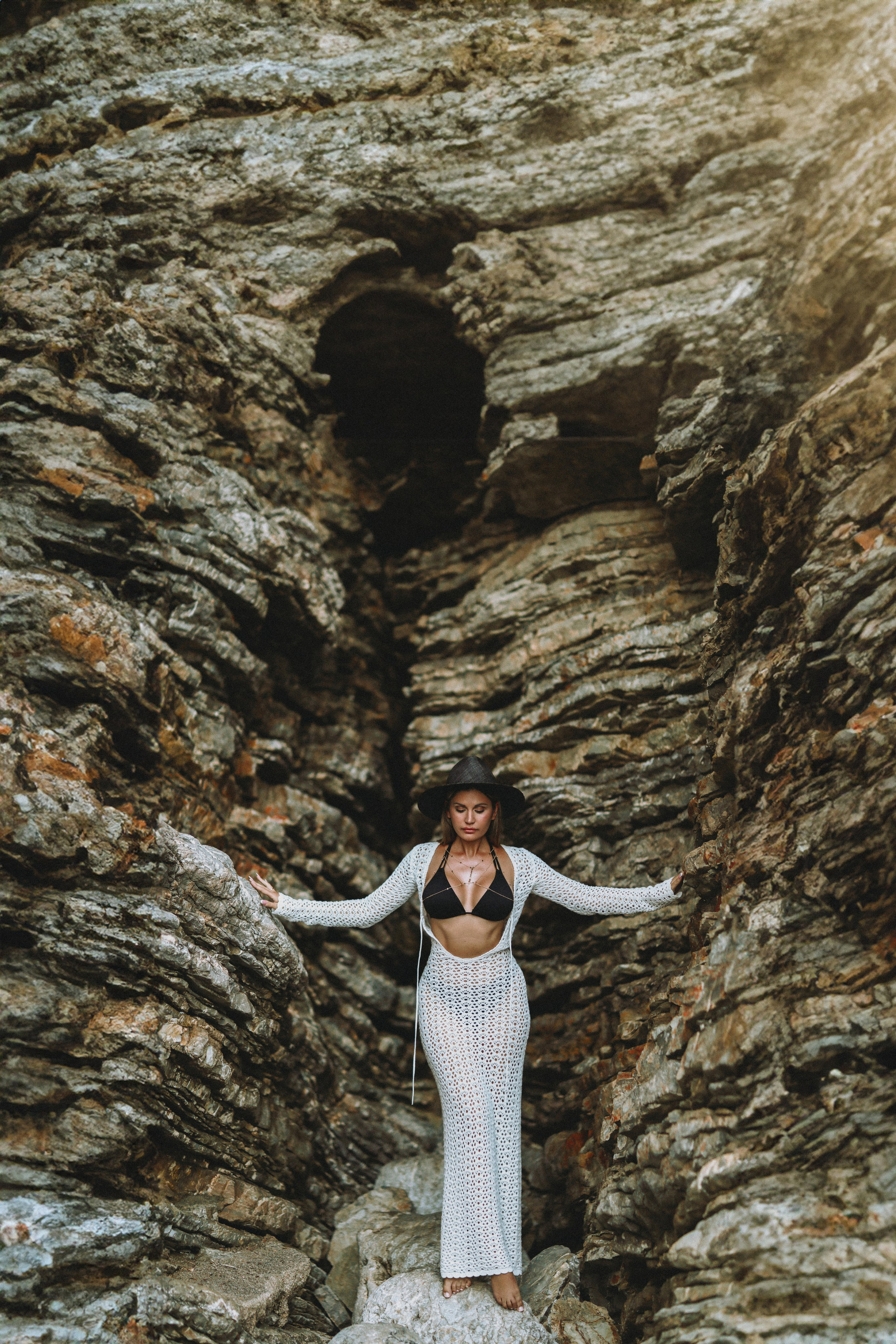 Bride posing in rocky canyon landscape in Montenegro during wedding session