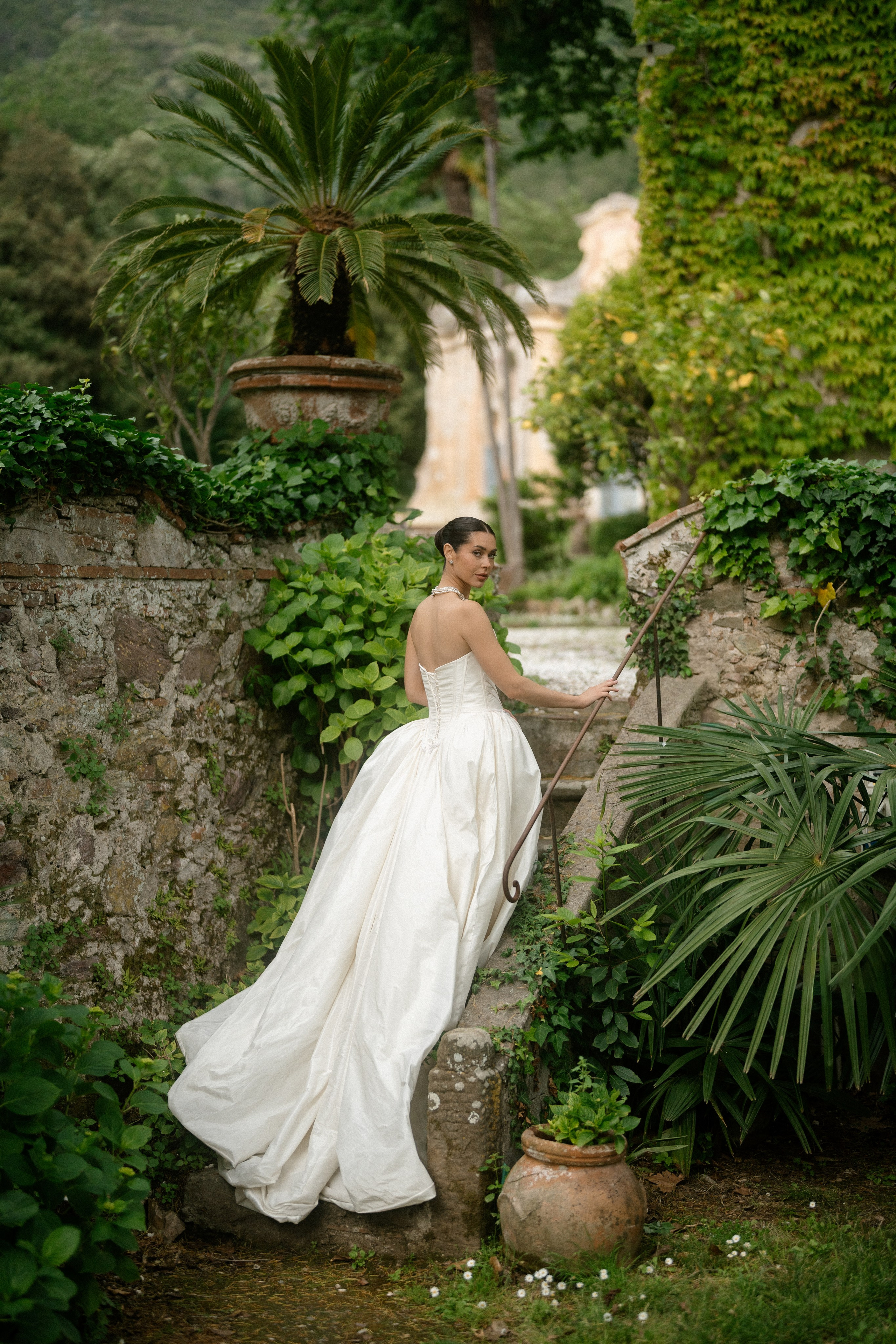 Bride with a lace veil partially covering her face, revealing one striking blue eye, captured in timeless and effortless wedding photography with an editorial style by a destination wedding photographer, evoking an intimate luxury bridal portrait in Lake Como, Italy.