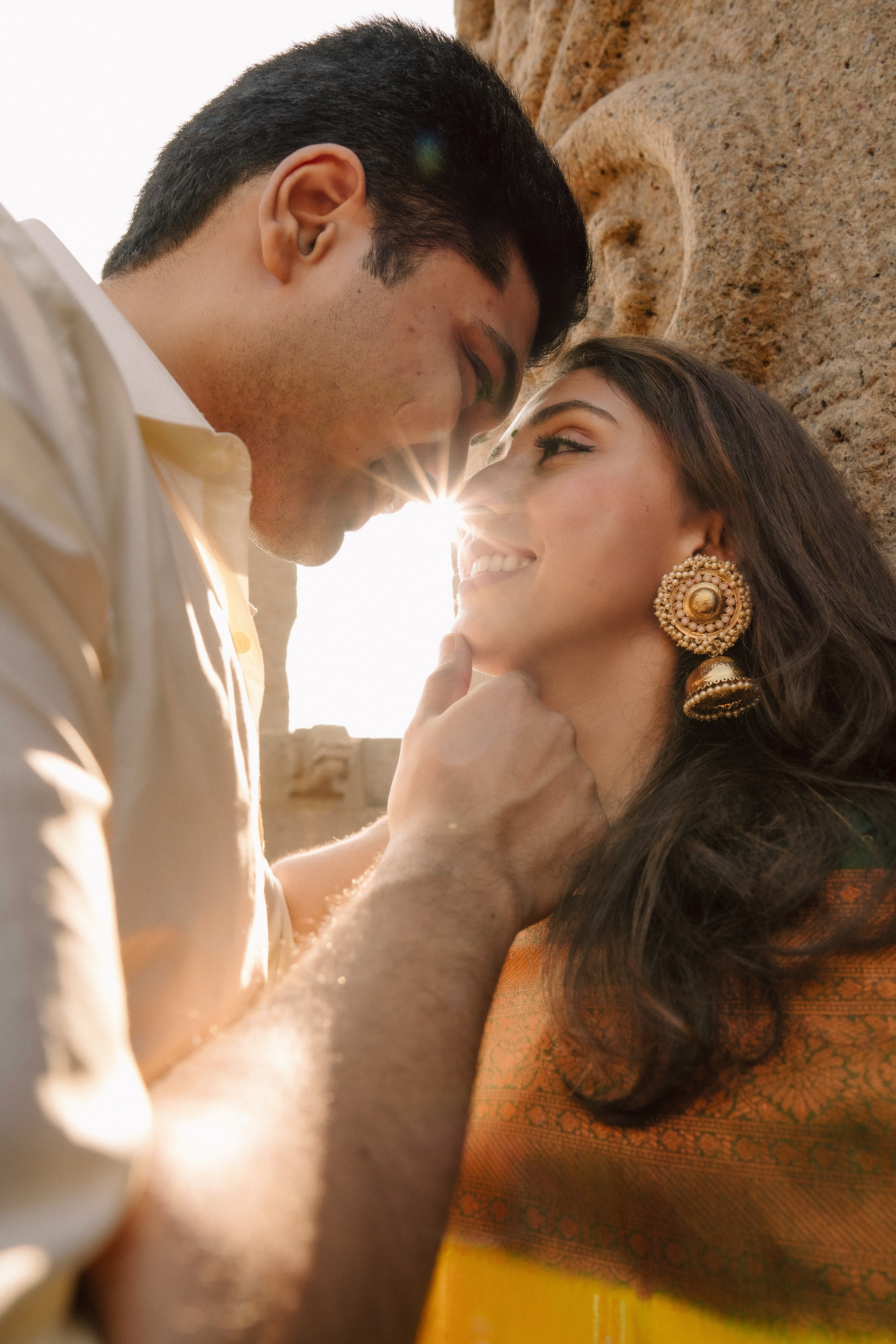 A romantic close-up of a couple sharing an intimate moment, eyes locked with love and warmth.