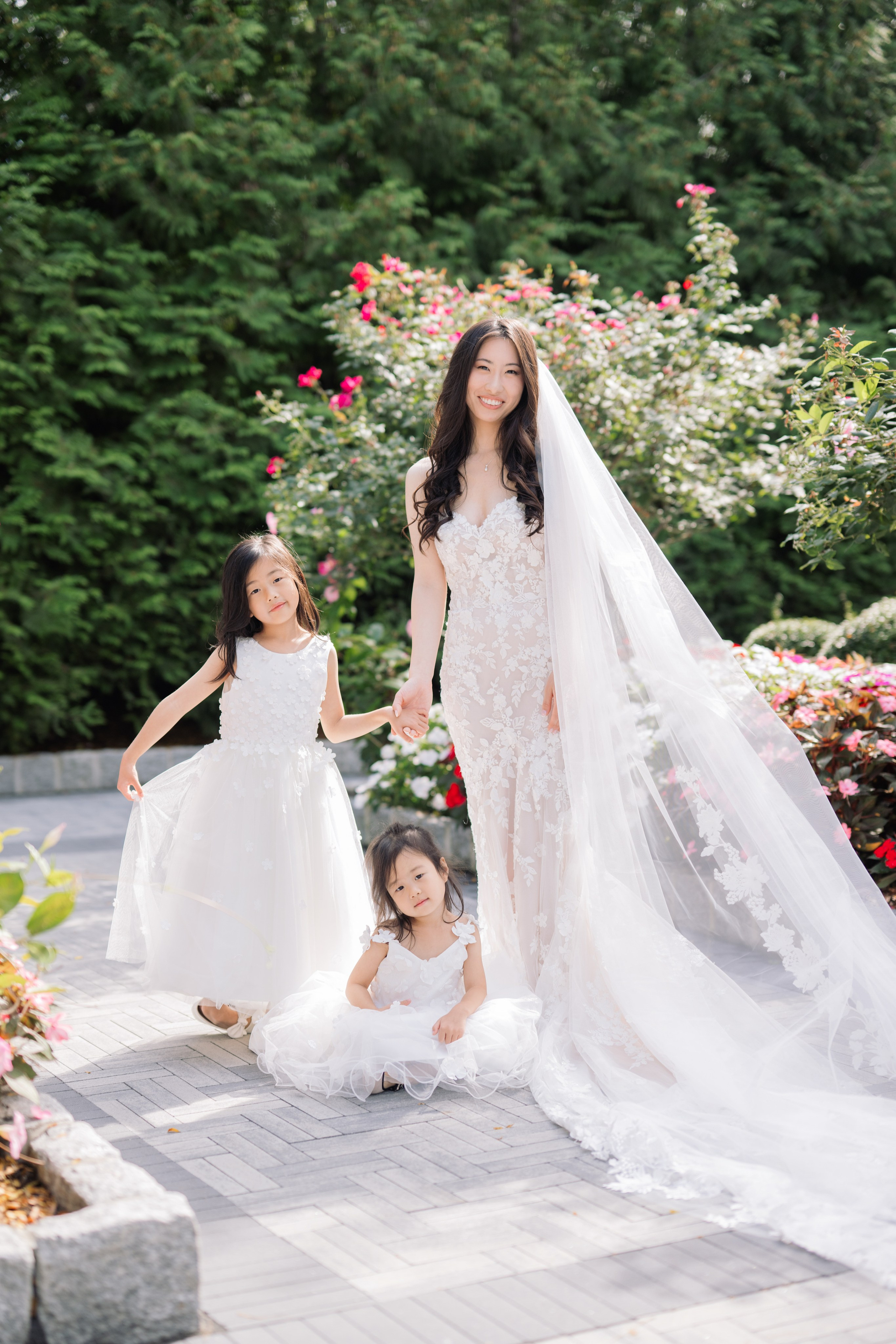 Bride walking with flower girls through the gardens at The Estate at Florentine Gardens