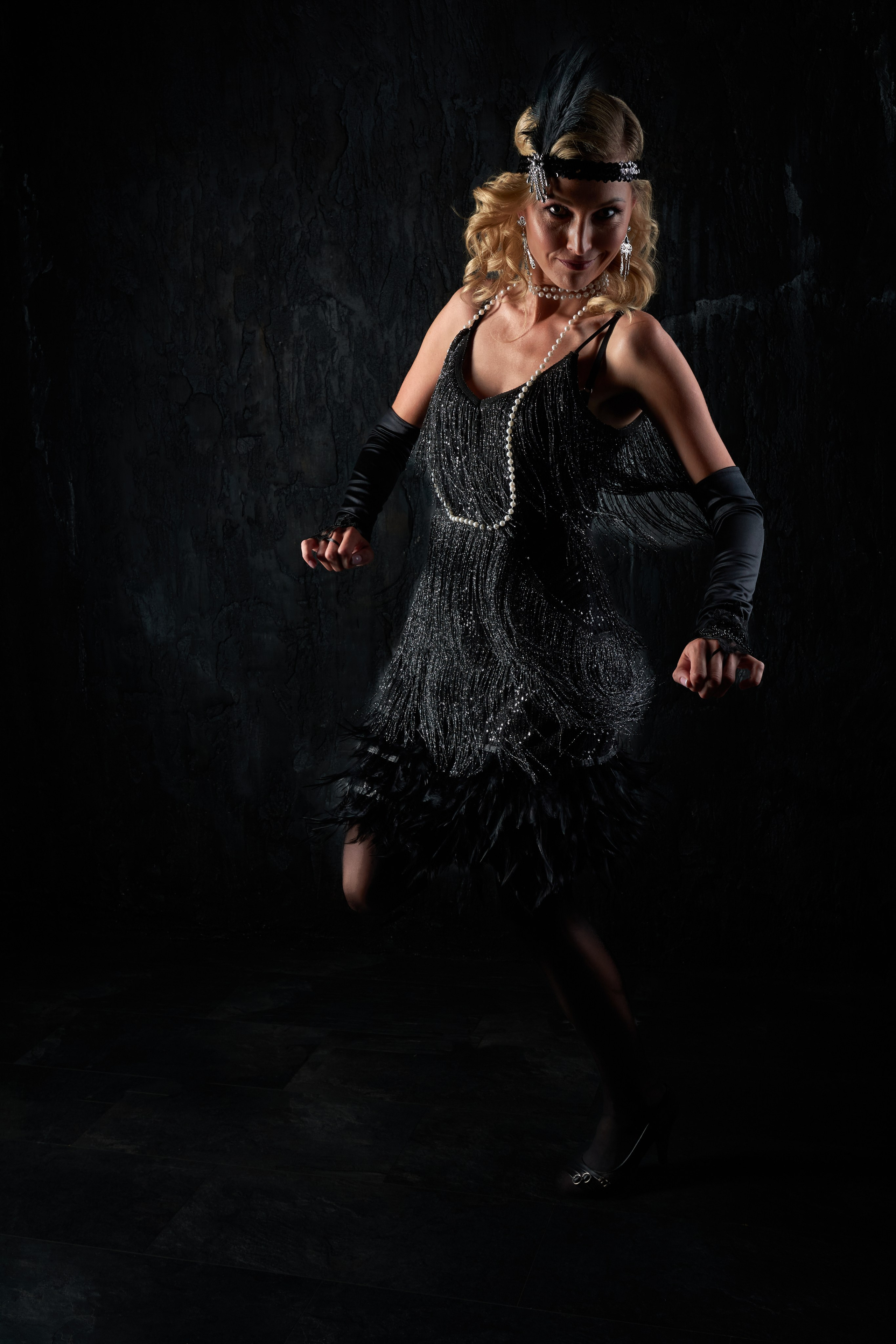 A flapper dances, looking at the camera — dynamic portrait from "Flappers: A Transformation"