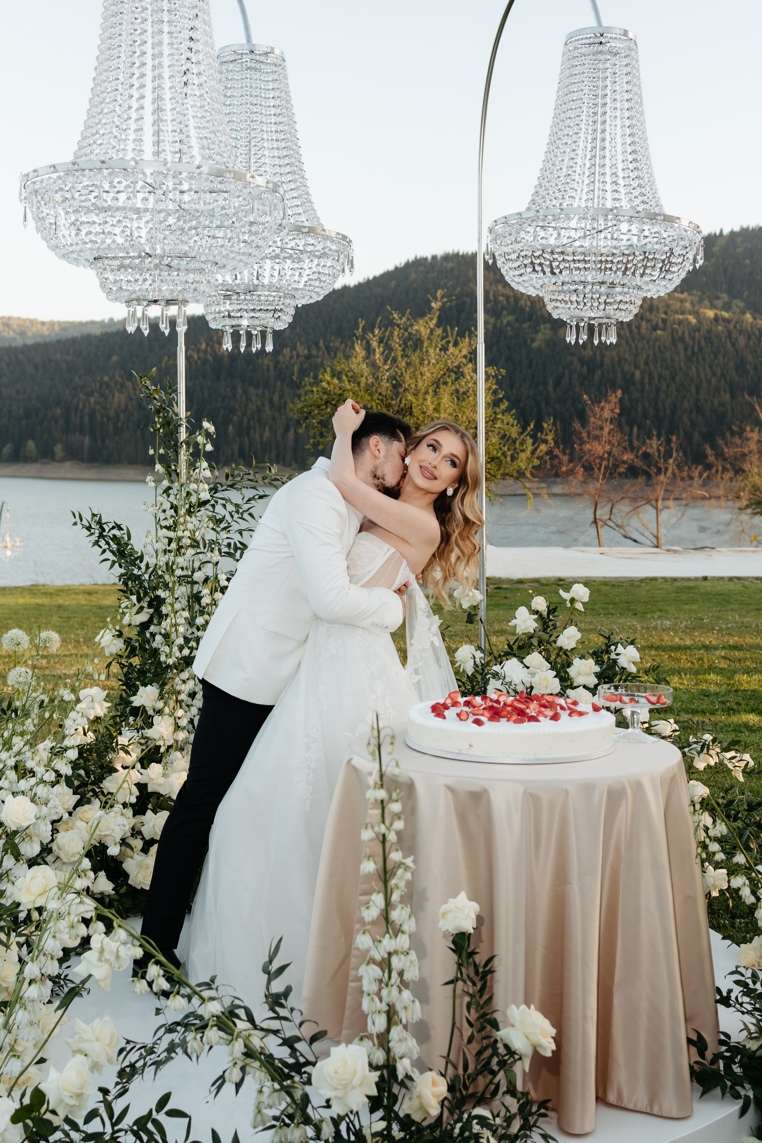 Editorial wedding portrait of a bride and groom sharing an intimate moment at the cake