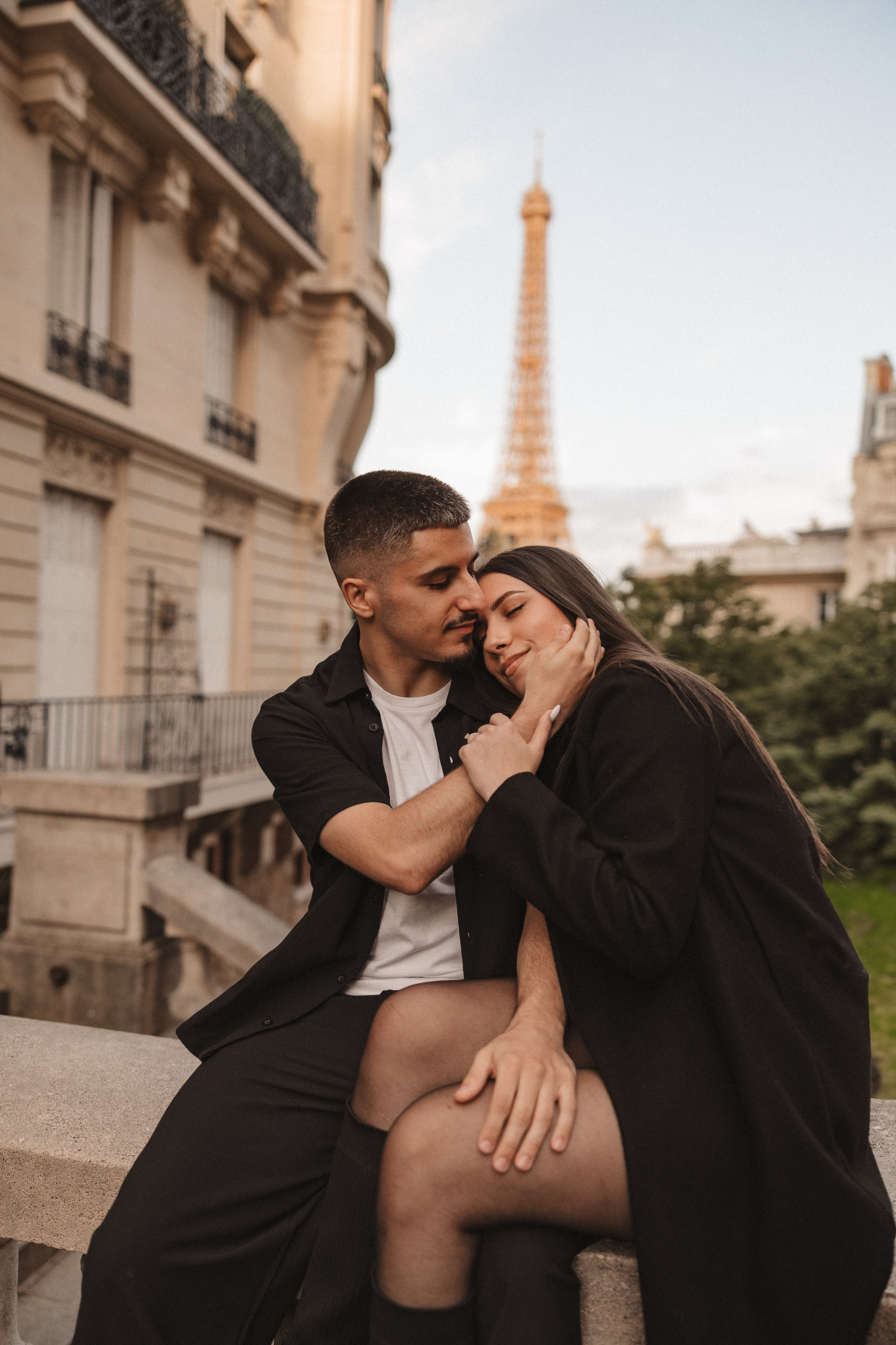 Bride and groom embracing during a photo session in Paris with the Eiffel Tower in the background