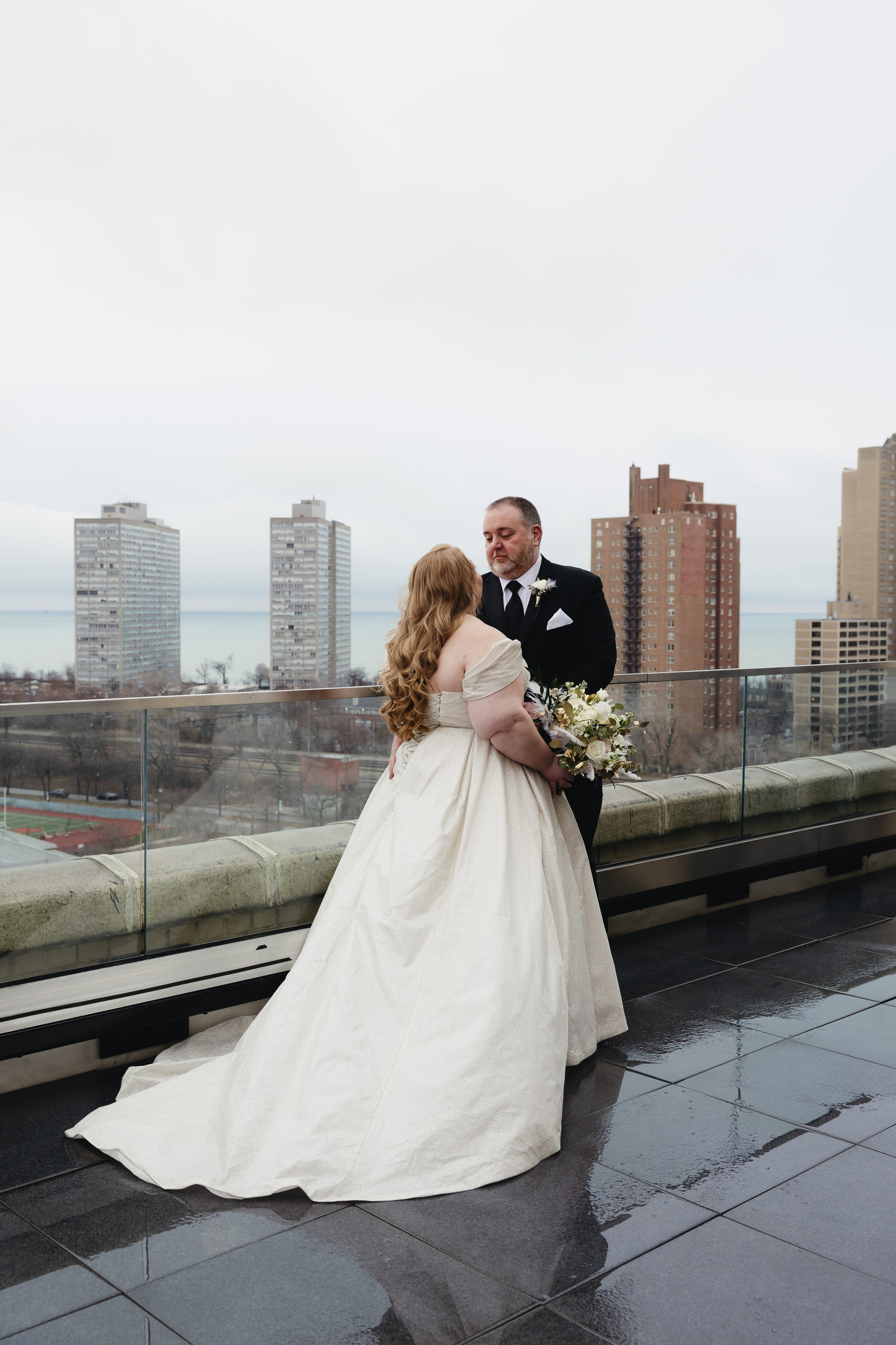 Bride and groom portrait on the rooftop overlooking Lake Michigan at The Penthouse Hyde Park wedding venue