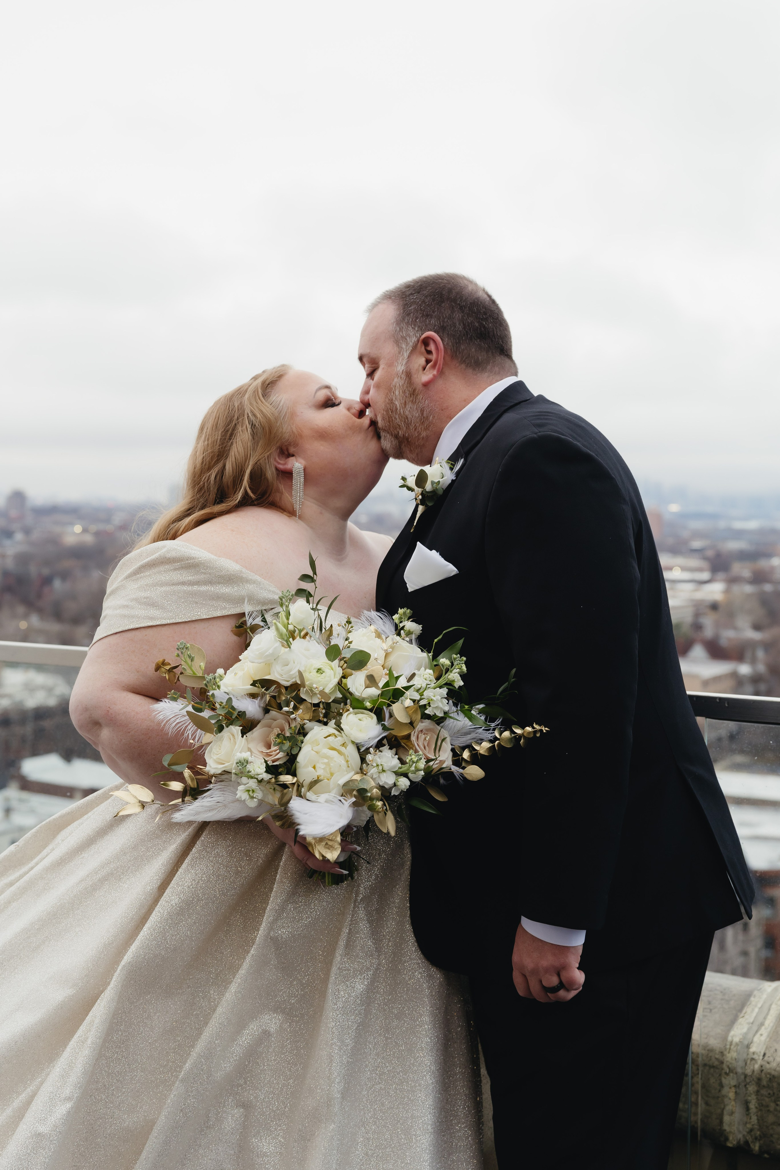 Close-up portrait of the bride and groom kissing on the rooftop at The Penthouse Hyde Park in Chicago