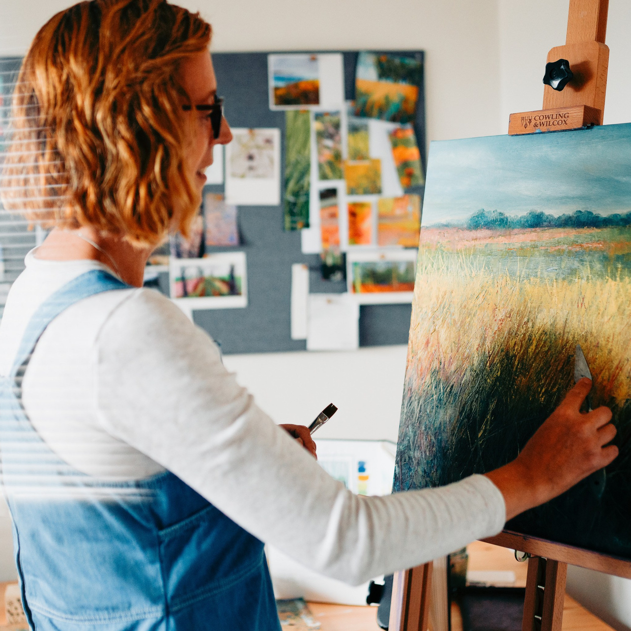 Creative brand photography of an artist painting in her studio in Solihull, capturing process and personality.