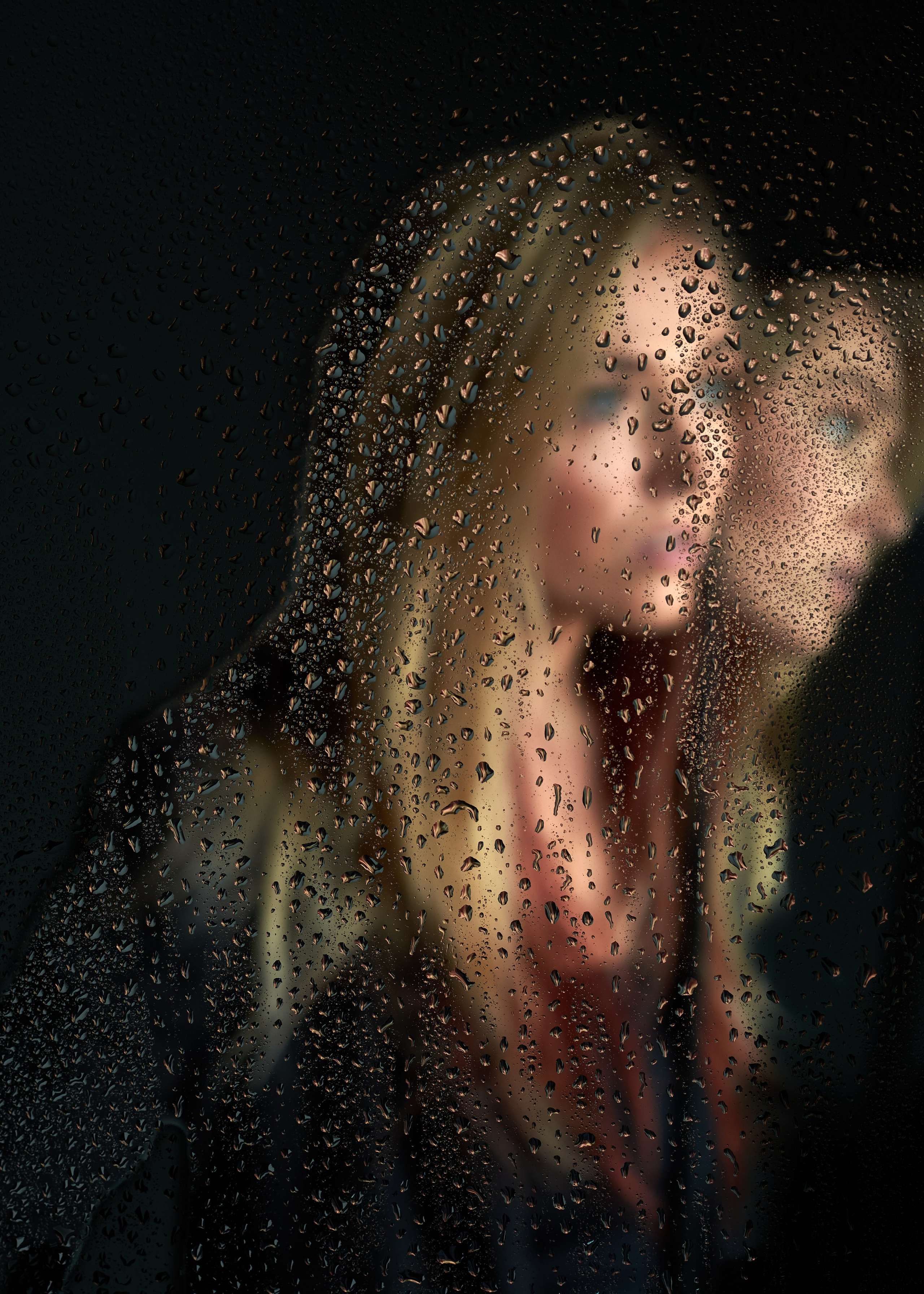 Figure obscured by rain-streaked glass