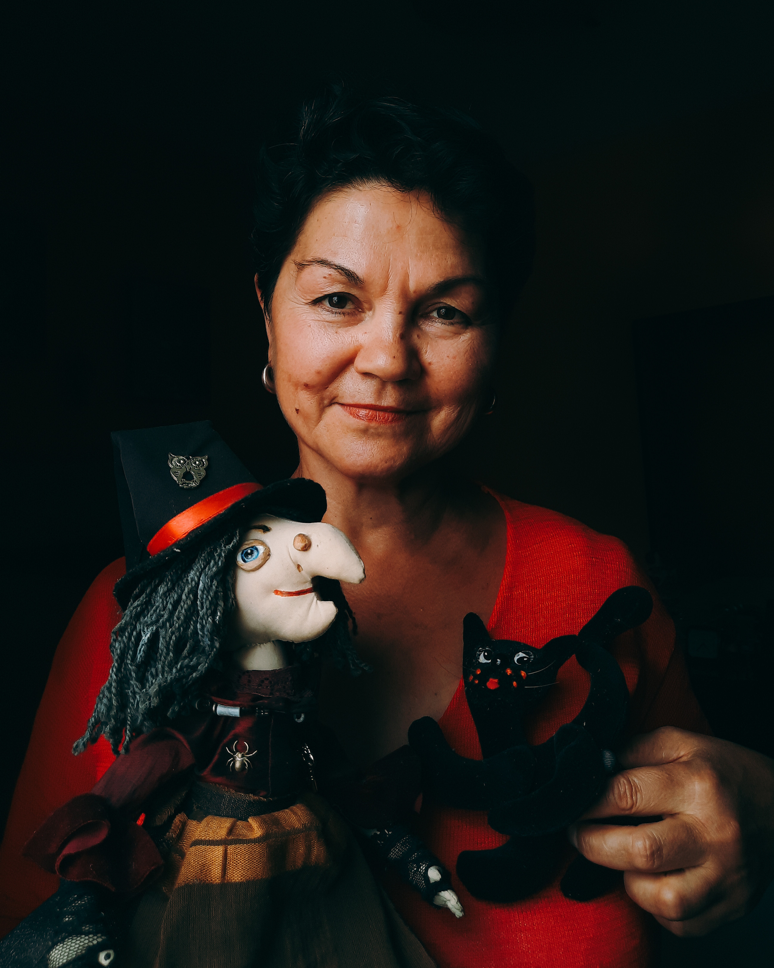 Lady in red portrait with Russian folklore doll. Online photo shoot.