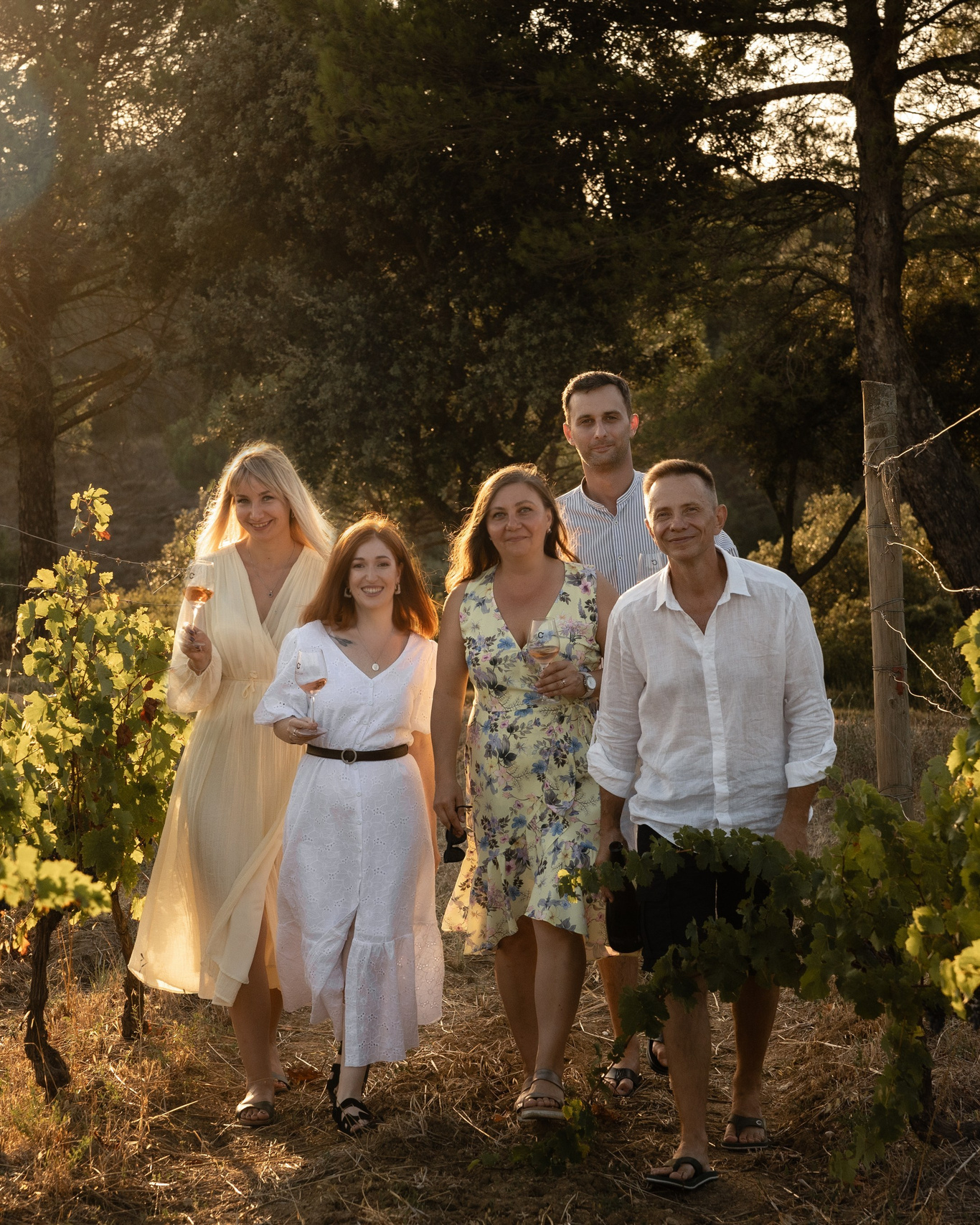 group of guests walking through a vineyard during an outdoor corporate event in France