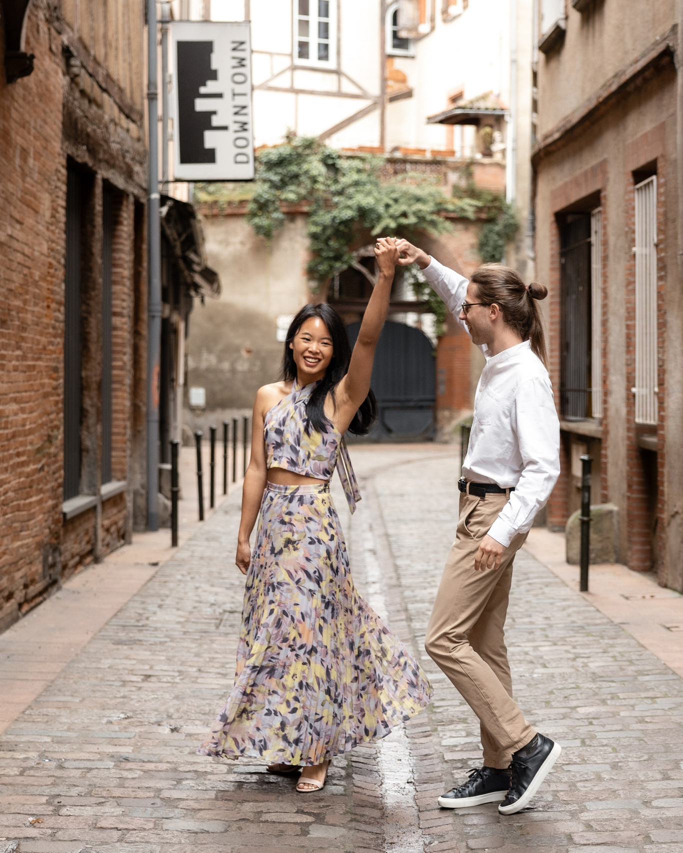 Couple dancing in historic Toulouse during engagement photography session