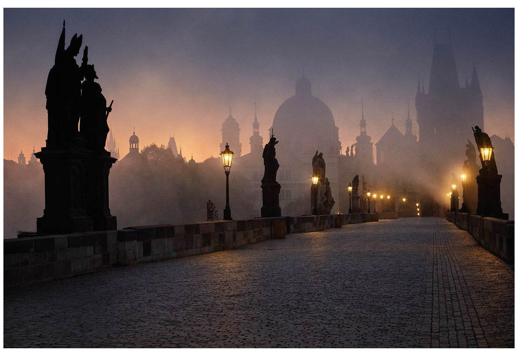 Fine art pre-dawn photograph of Charles Bridge in November fog — statues silhouetted against an amber and purple sky, gas lamps glowing through the mist, Prague — Kurt Vinion Photography