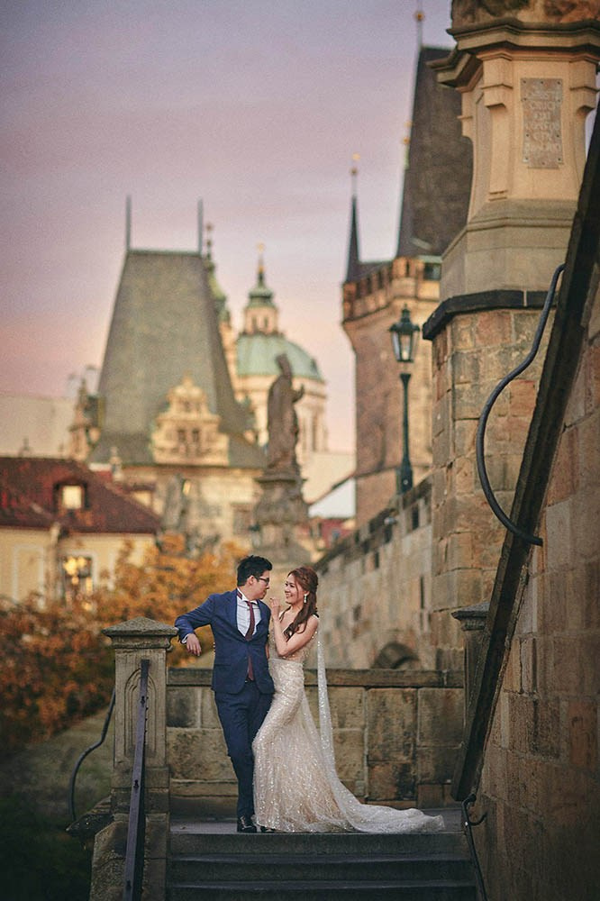 Couple's intimate embrace on Kampa Steps, Prague sunrise.